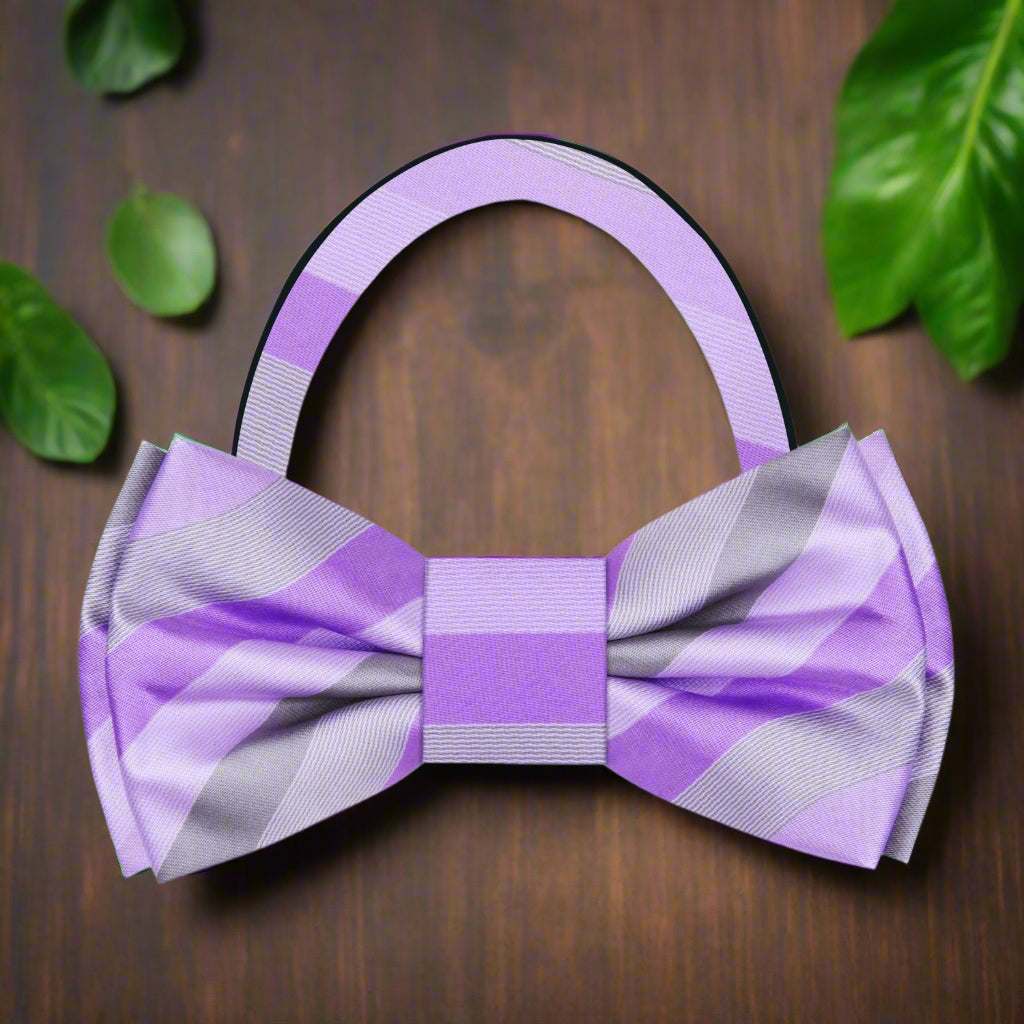 Close-up of charming pastel striped bow tie against a light background.