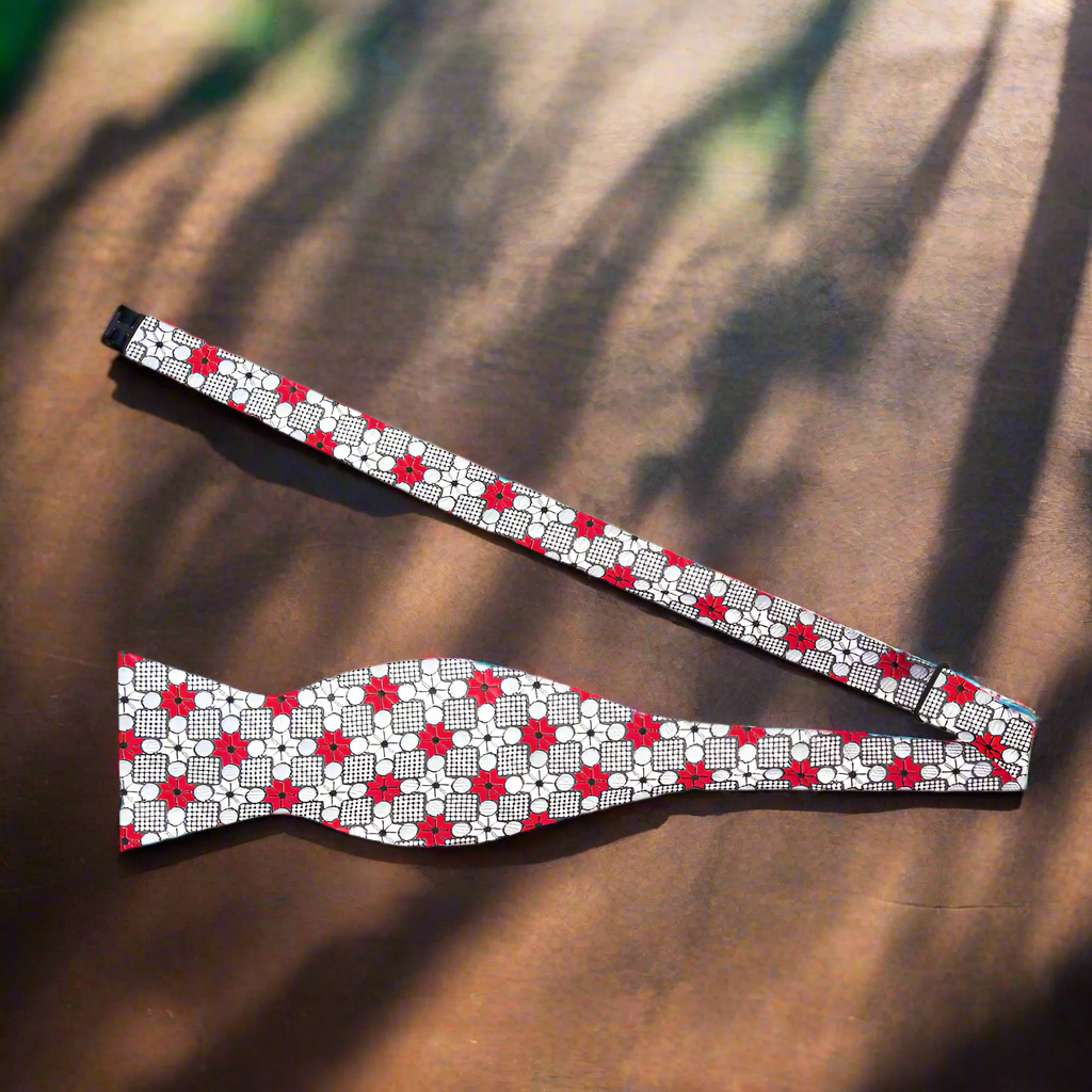 Crimson Burst Silk Bow Tie displayed on a white dress shirt, highlighting its geometric pattern.