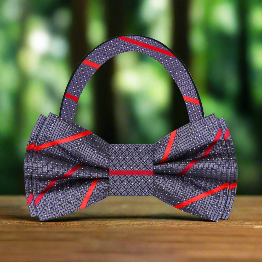 Close-up view of a dark blue silk bow tie with a brown stripe pattern, ideal for weddings