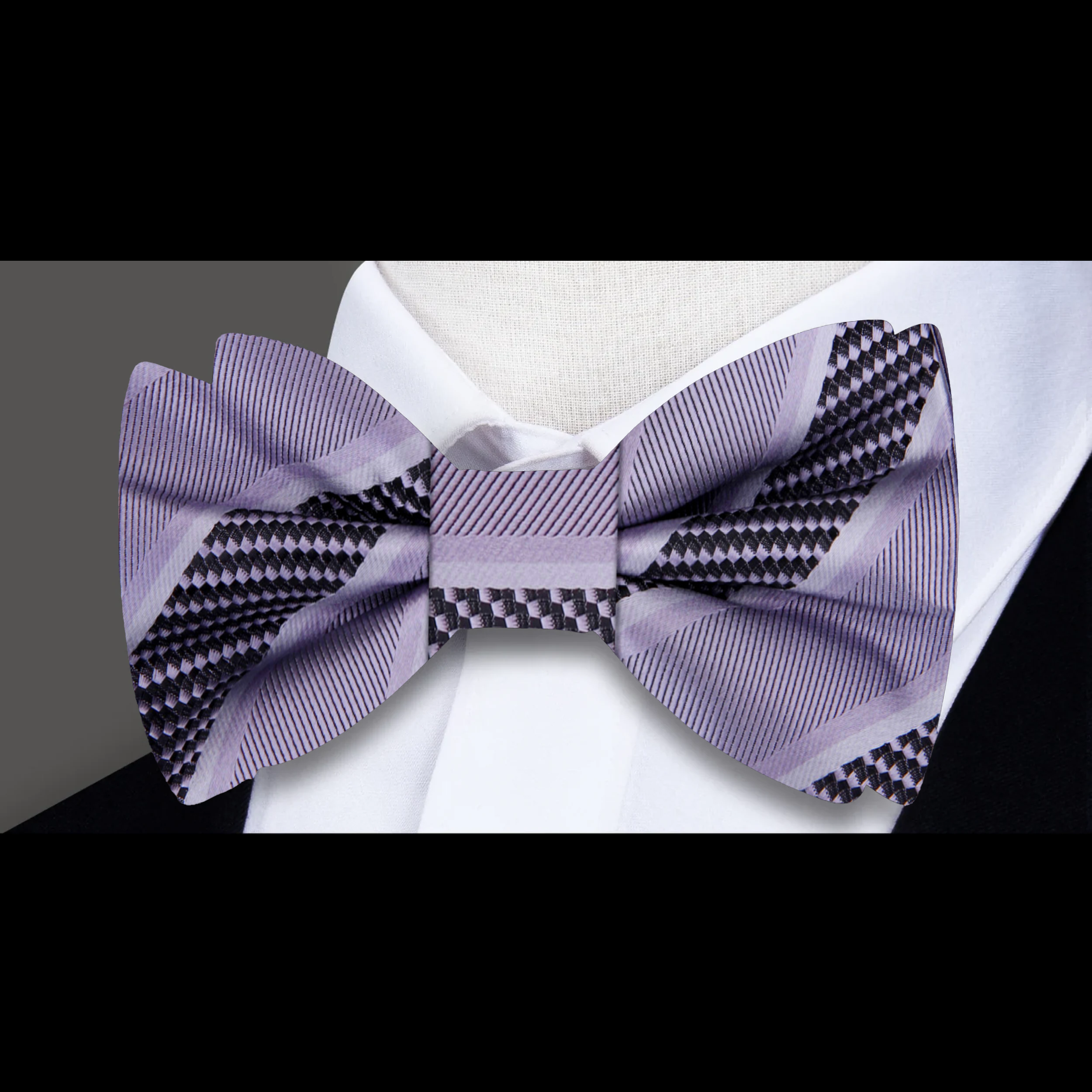 Close-up of the fabric pattern and texture of a yellow gold striped bow tie