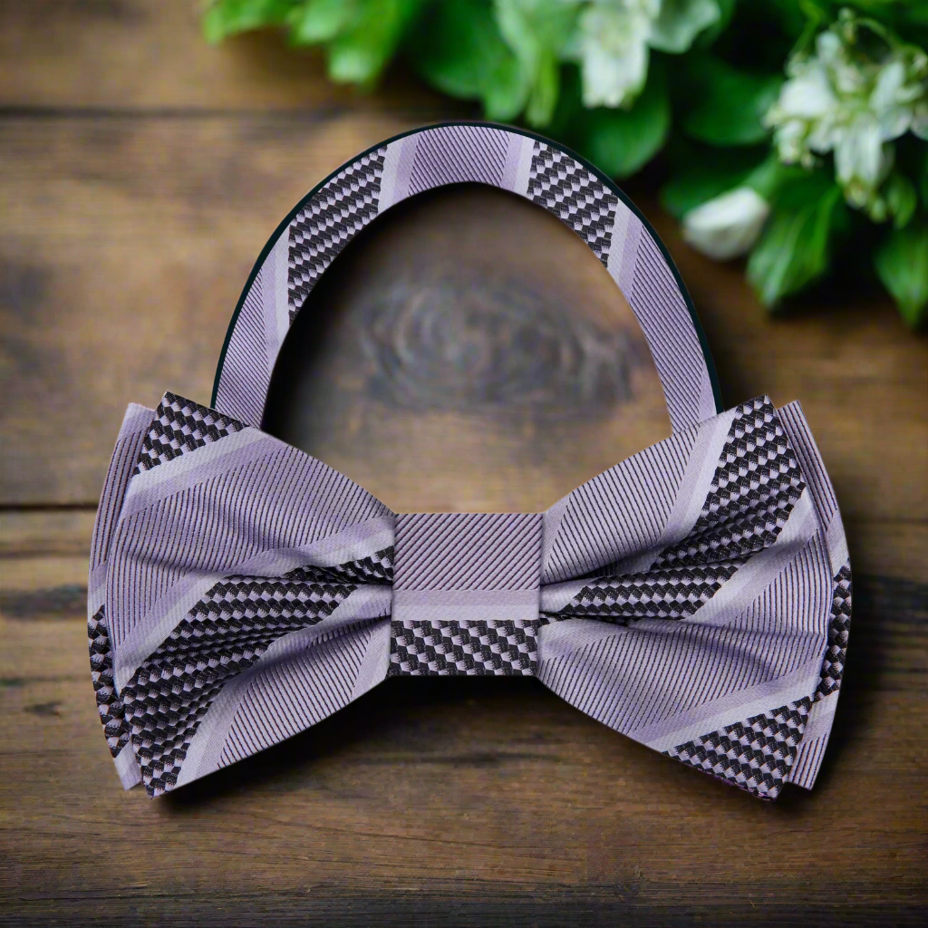 Model wearing a silk striped bow tie with a navy suit for a formal event
