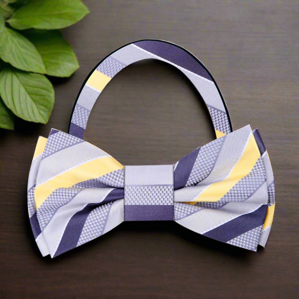 Elegant grey and purple stripe bow tie displayed on a suit