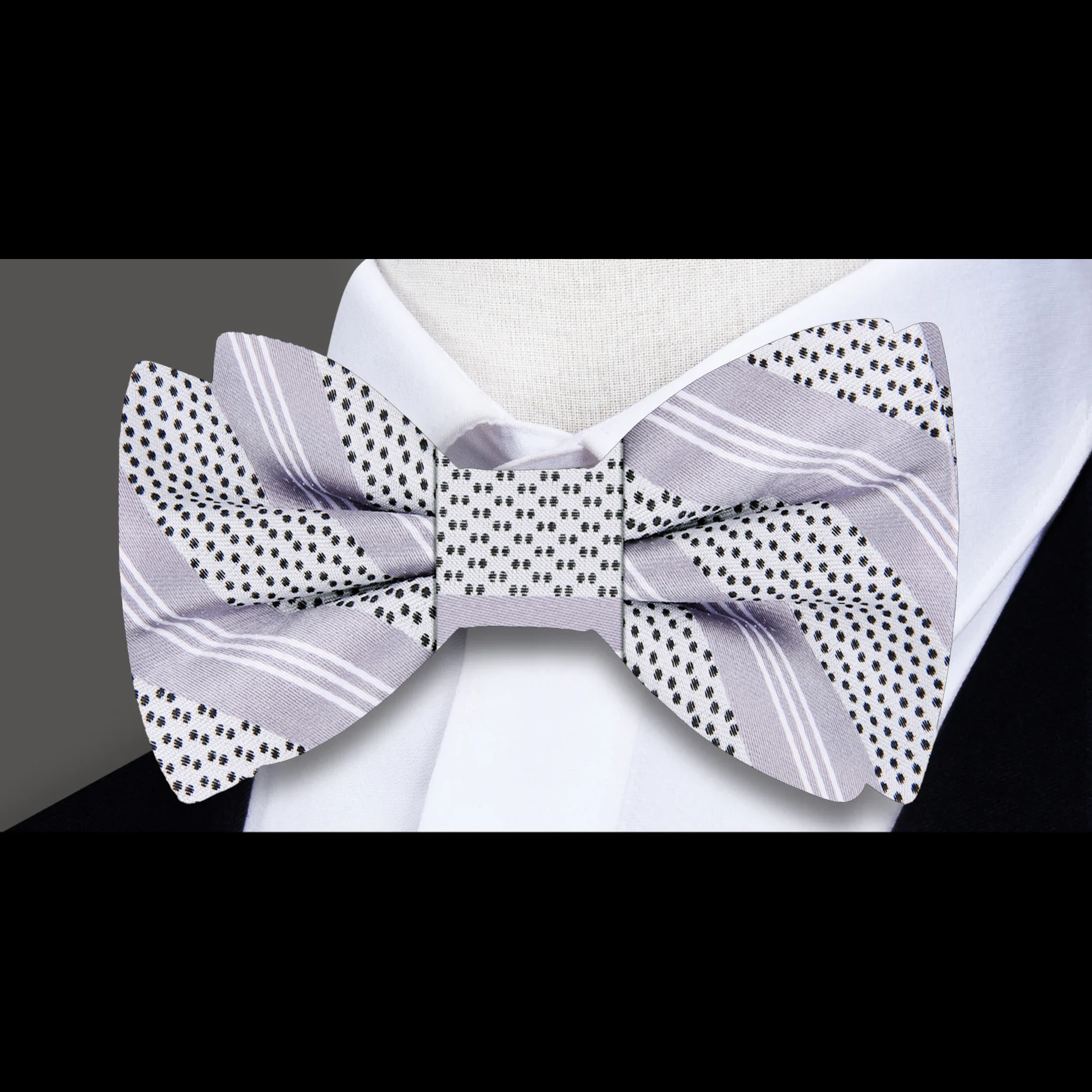Stylish silver striped silk bow tie showcased with a charcoal suit, perfect for evening receptions.