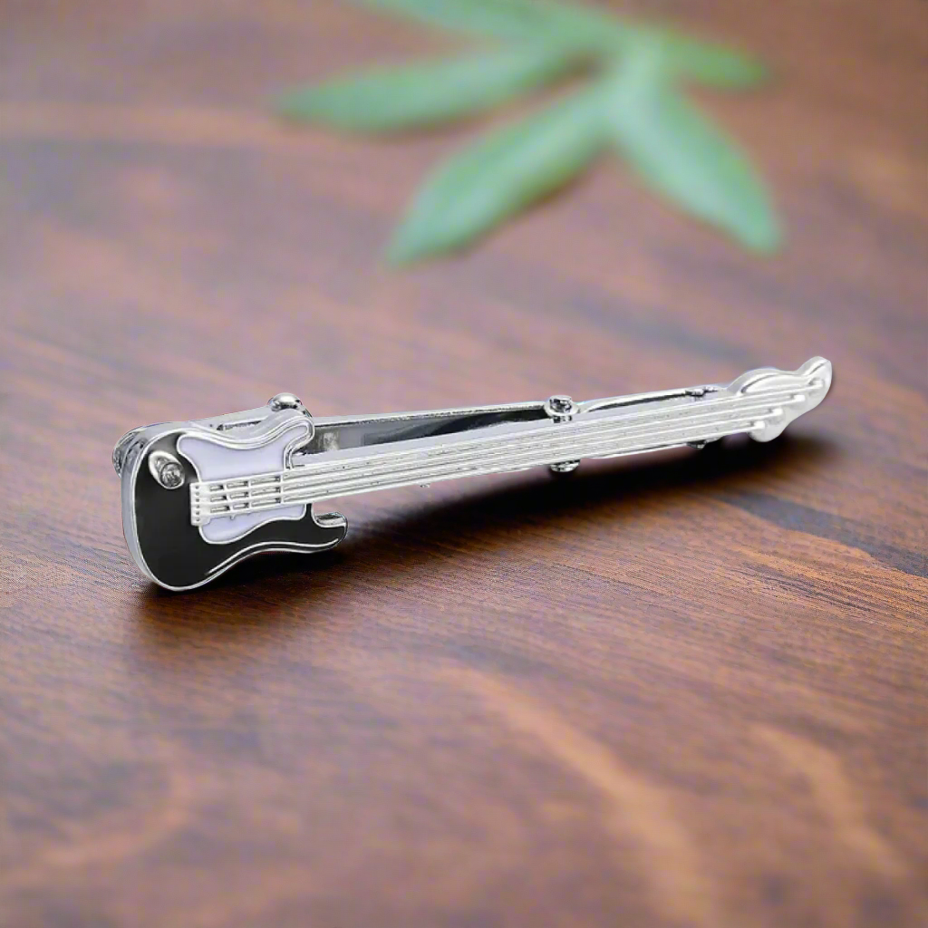 Guitar tie bar positioned neatly against a solid black dress shirt.