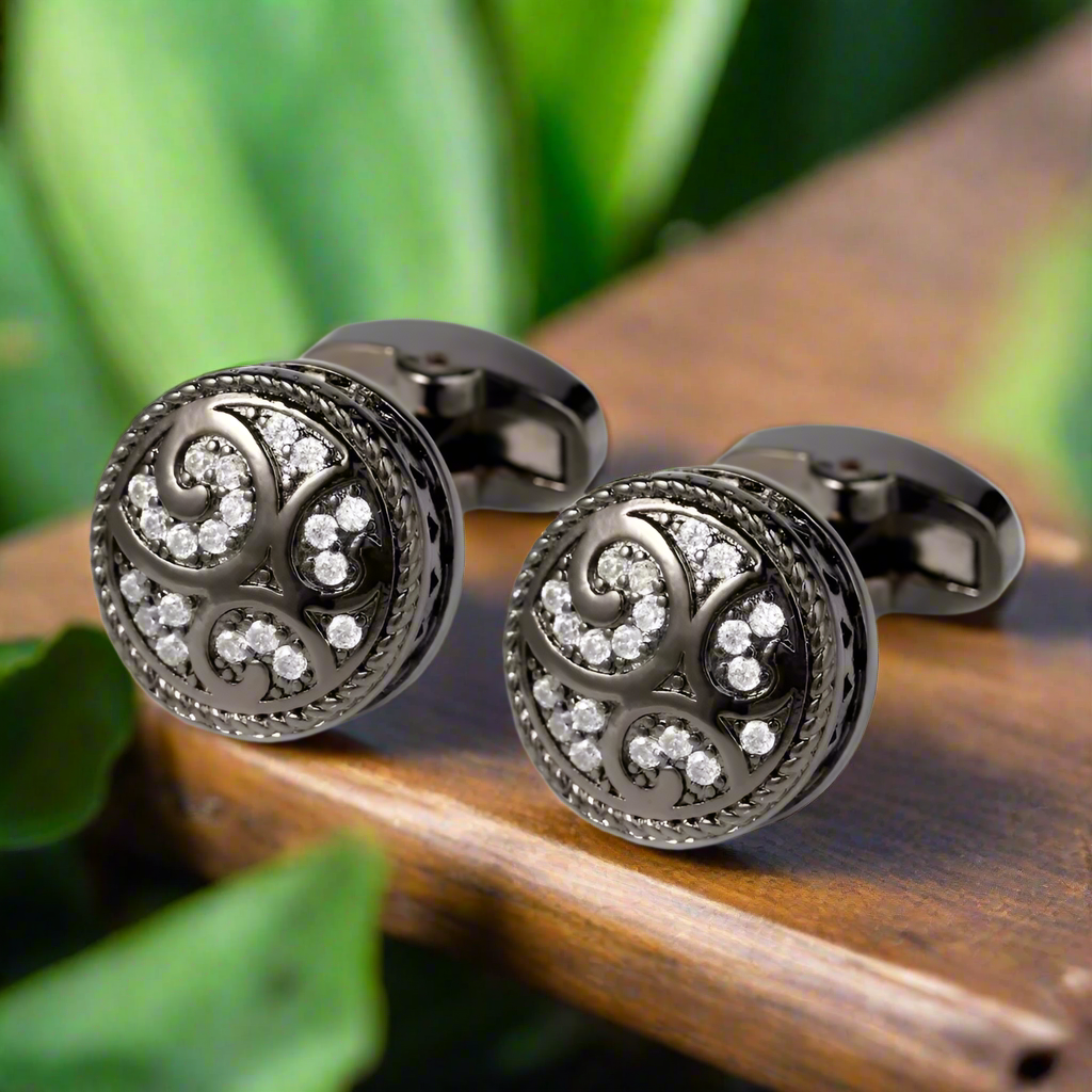 Gunmetal cufflinks displayed against a charcoal grey suit, perfect for formal wear.