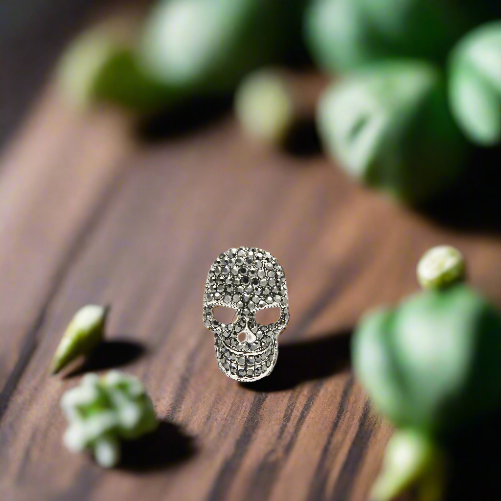 Mens skull lapel pin worn on a black suit, adding a touch of elegance and edge.