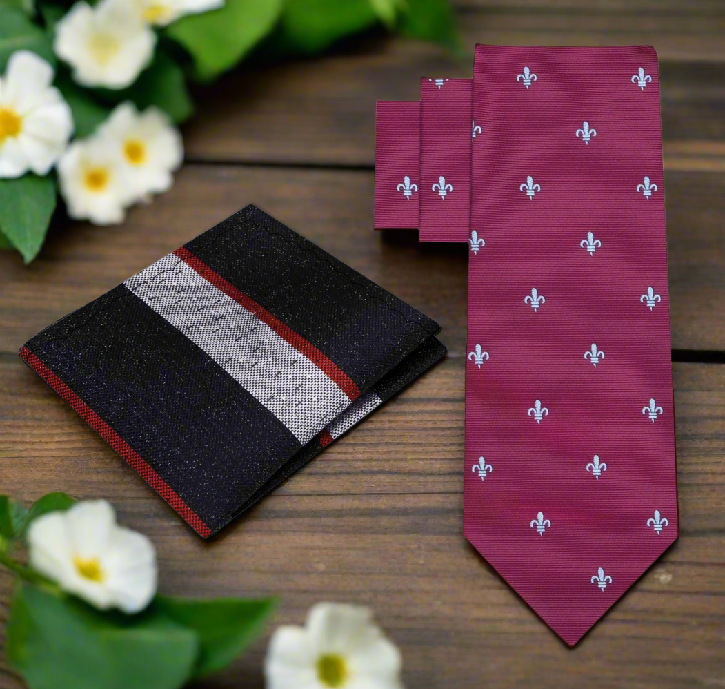 Elegant deep red silk necktie with fleur-de-lis design, displayed on a white shirt.