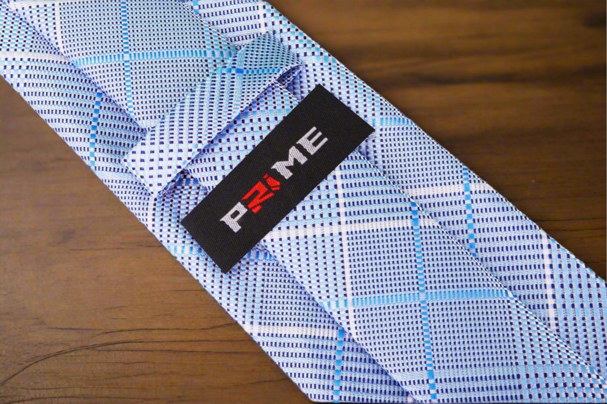 Man wearing stylish mens ties for weddings with blue plaid tie and white shirt