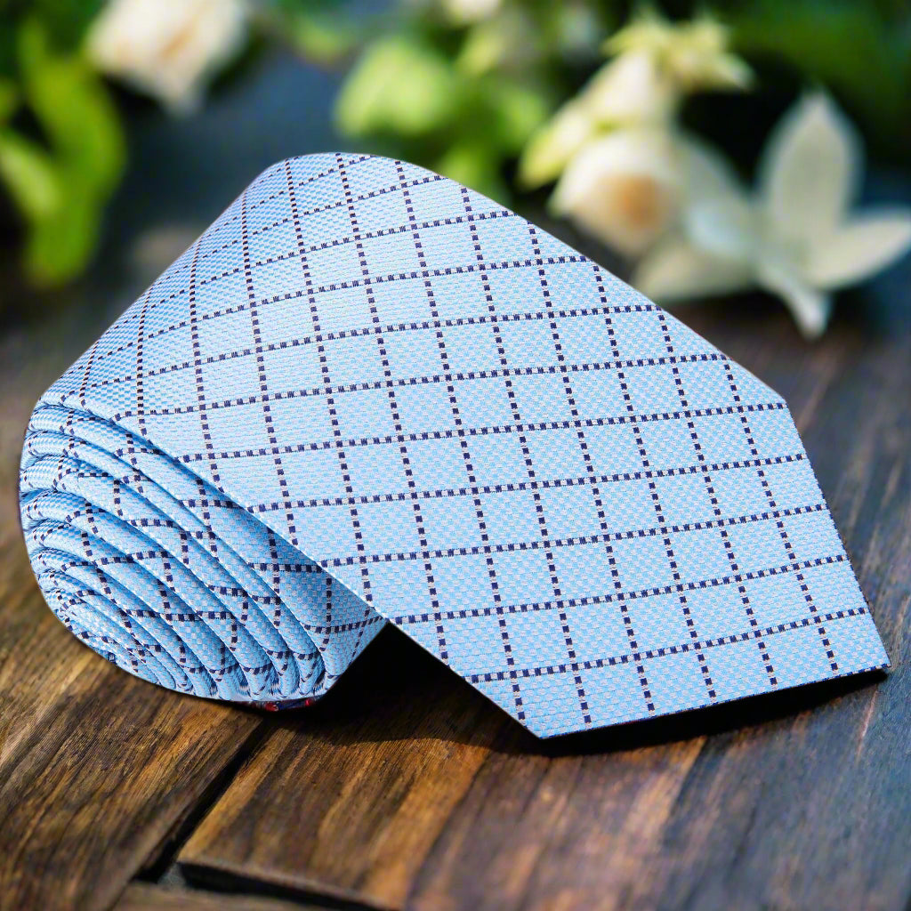 Close-up of light blue plaid silk necktie with classic pattern for men