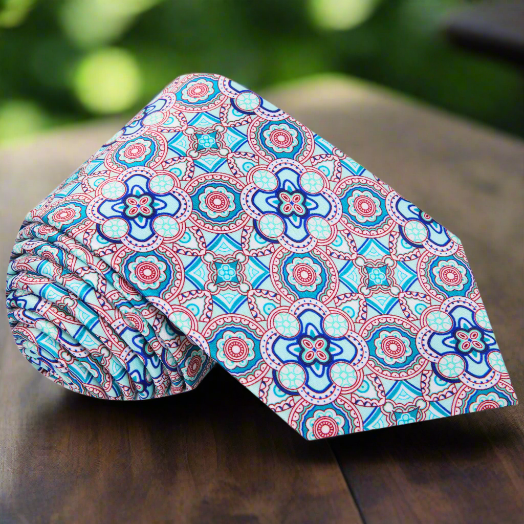 Front view of blue mosaic silk necktie with intricate pattern