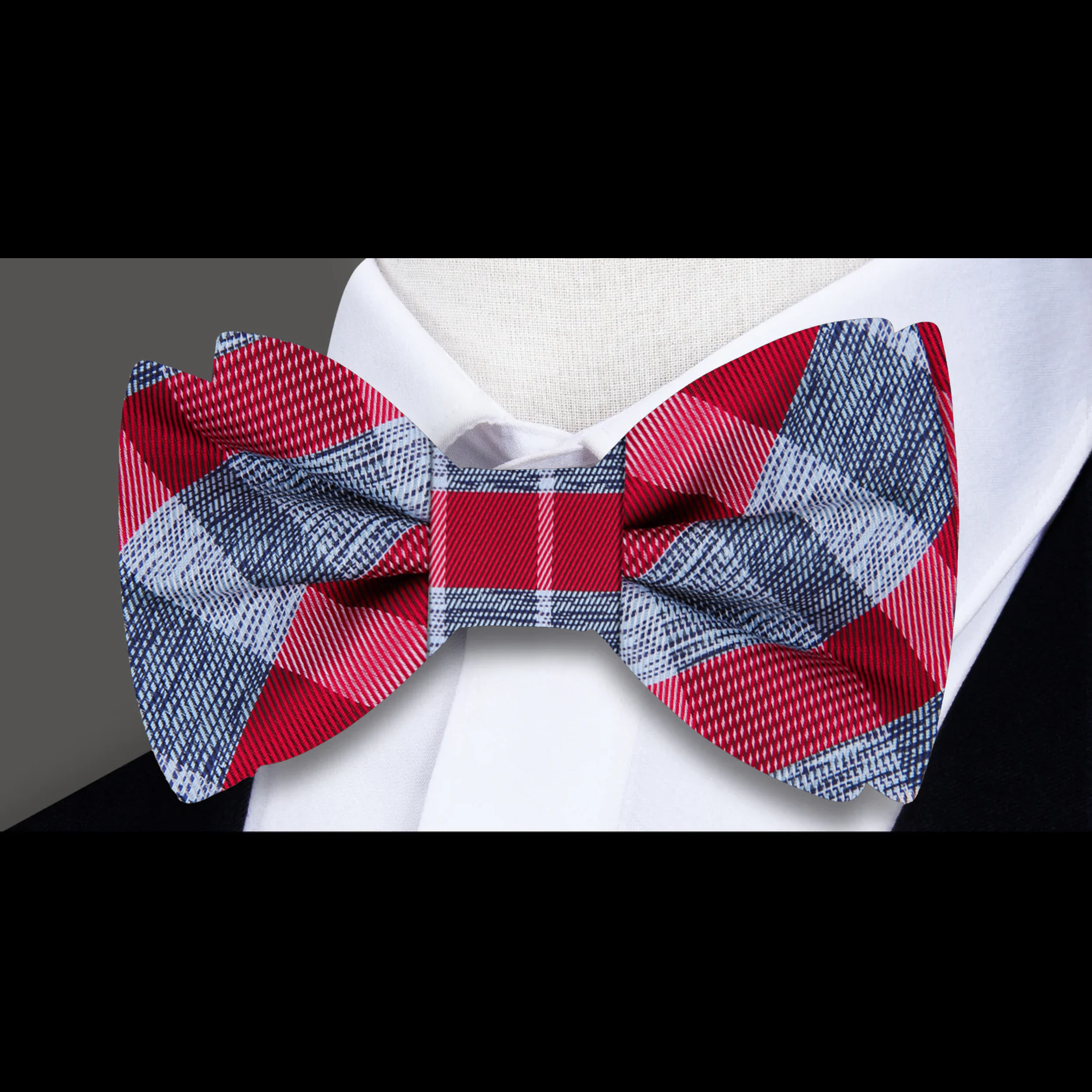 Model wearing plaid bow tie and matching pocket square with suit