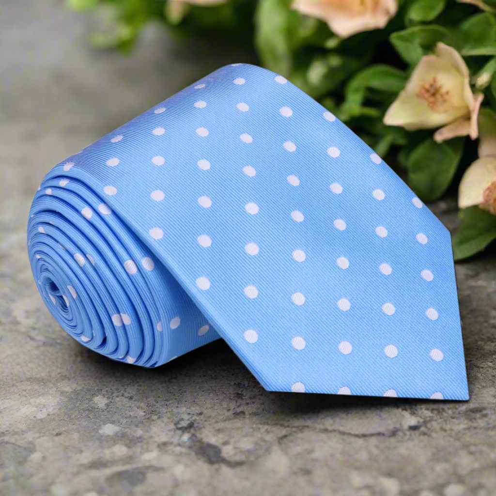 Light blue polka dot silk necktie draped over a dress shirt for wedding attire