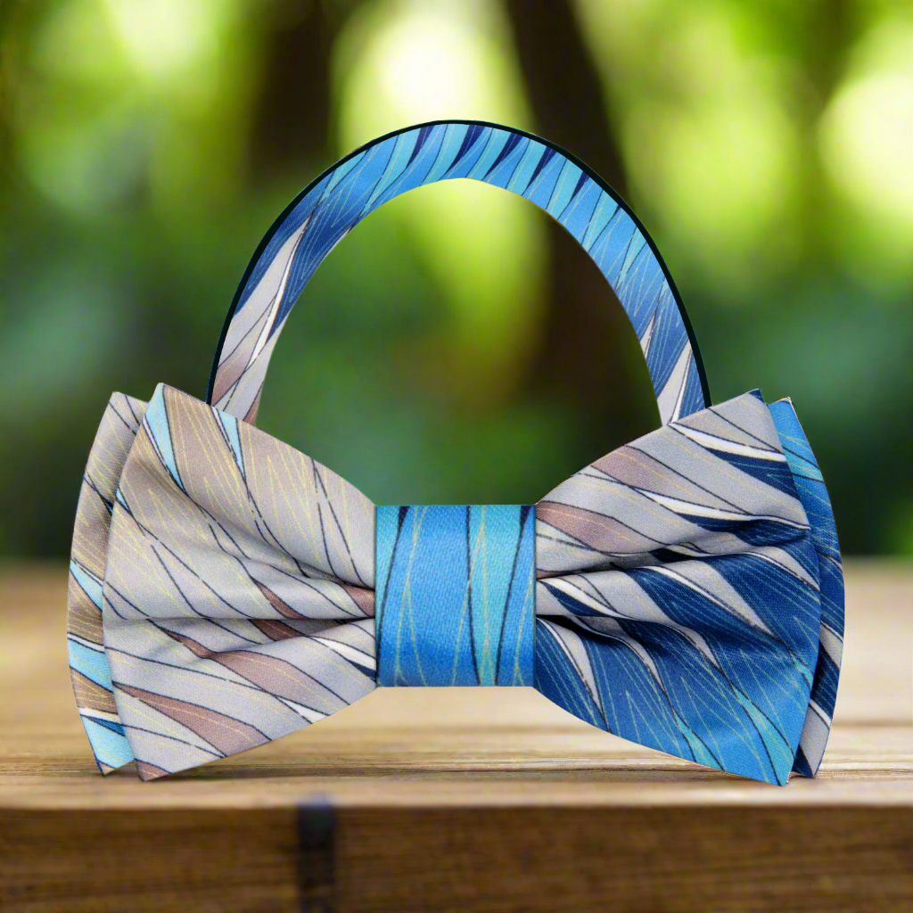 Close-up of silk abstract diamonds bow tie in blue and brown shades