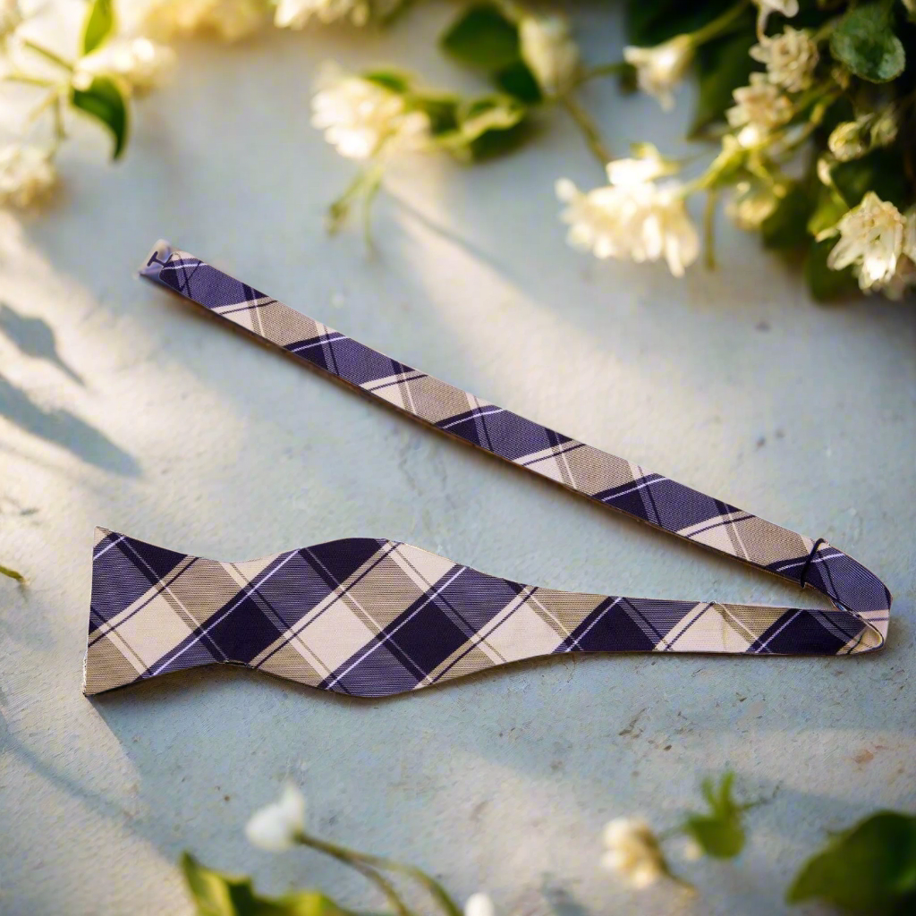Fashionable man wearing a plaid bow tie with a shirt and blazer, ideal for evening outings