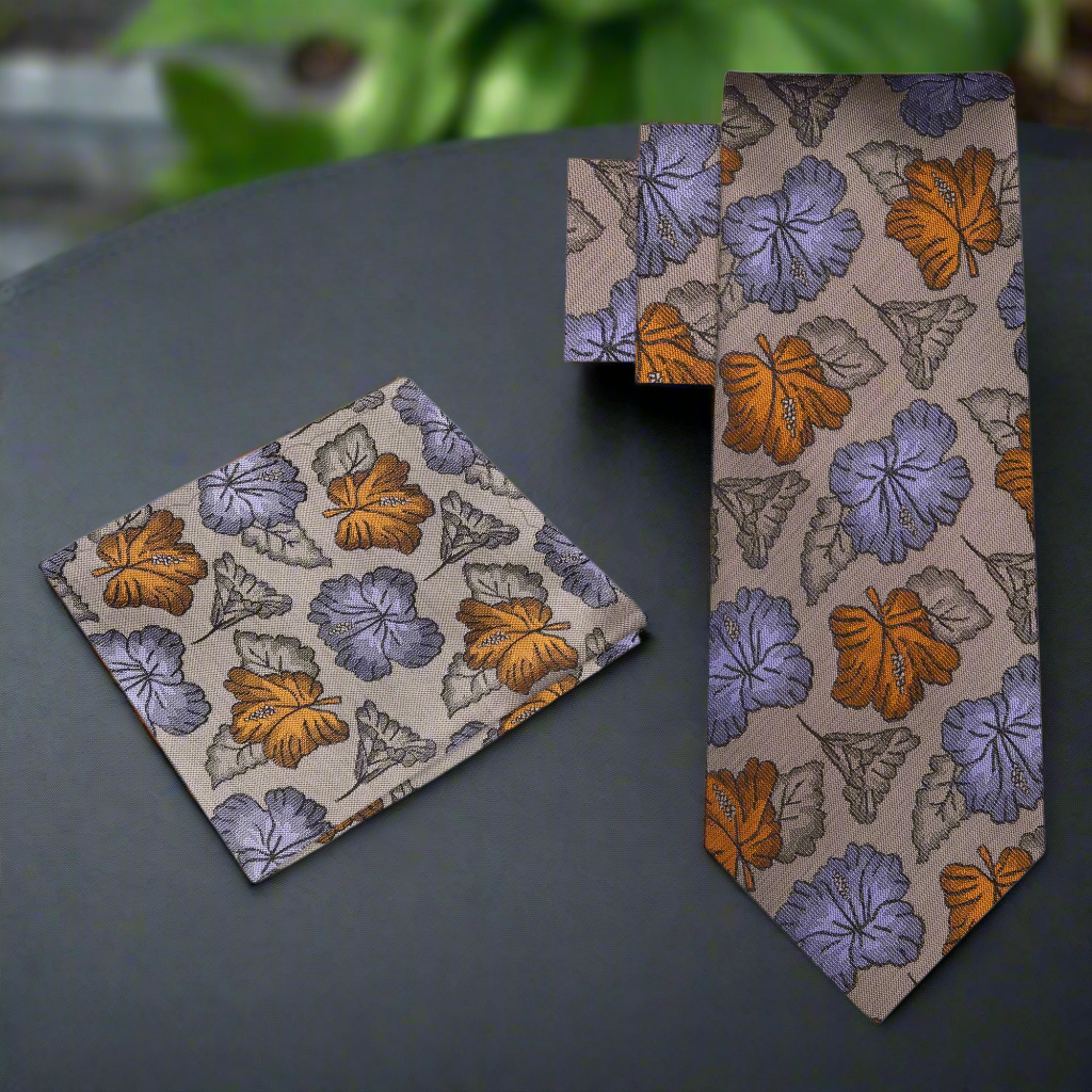 Close-up of a floral silk necktie in light brown with purple and amber accents, ideal for formal wear
