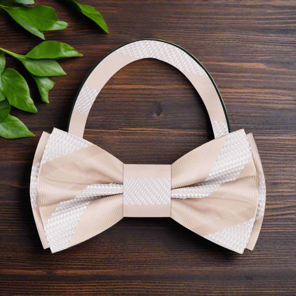 Model wearing a silk striped bow tie with a navy suit for a formal event