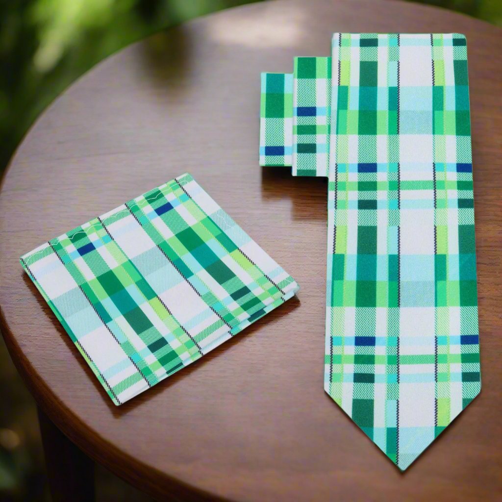 View of the elegant green plaid silk necktie with handkerchief set on a wooden table, showcasing its vibrant colors.