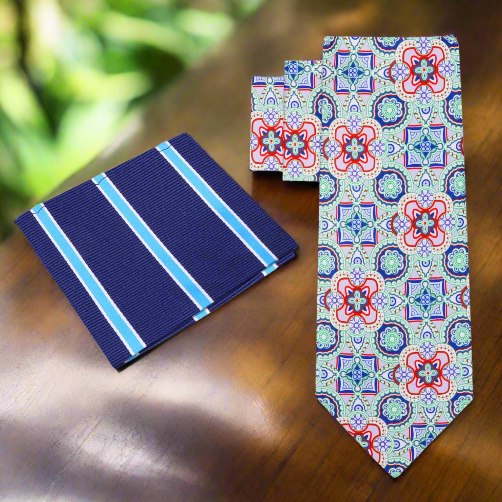 Model wearing a colorful mosaic necktie with a navy blue suit at an outdoor wedding.