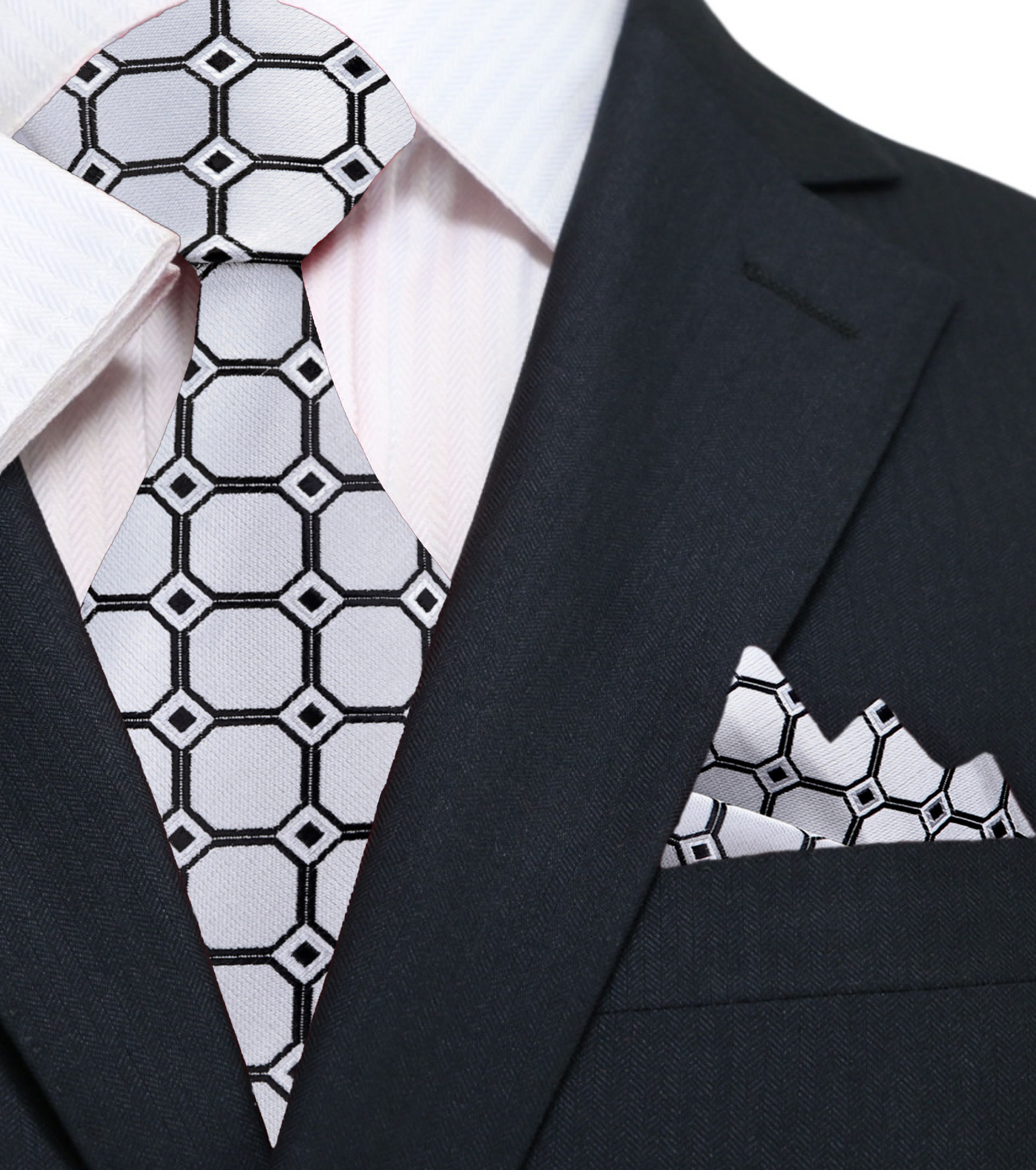 Silver and pink geometric silk tie paired with a light grey suit for a sophisticated look.