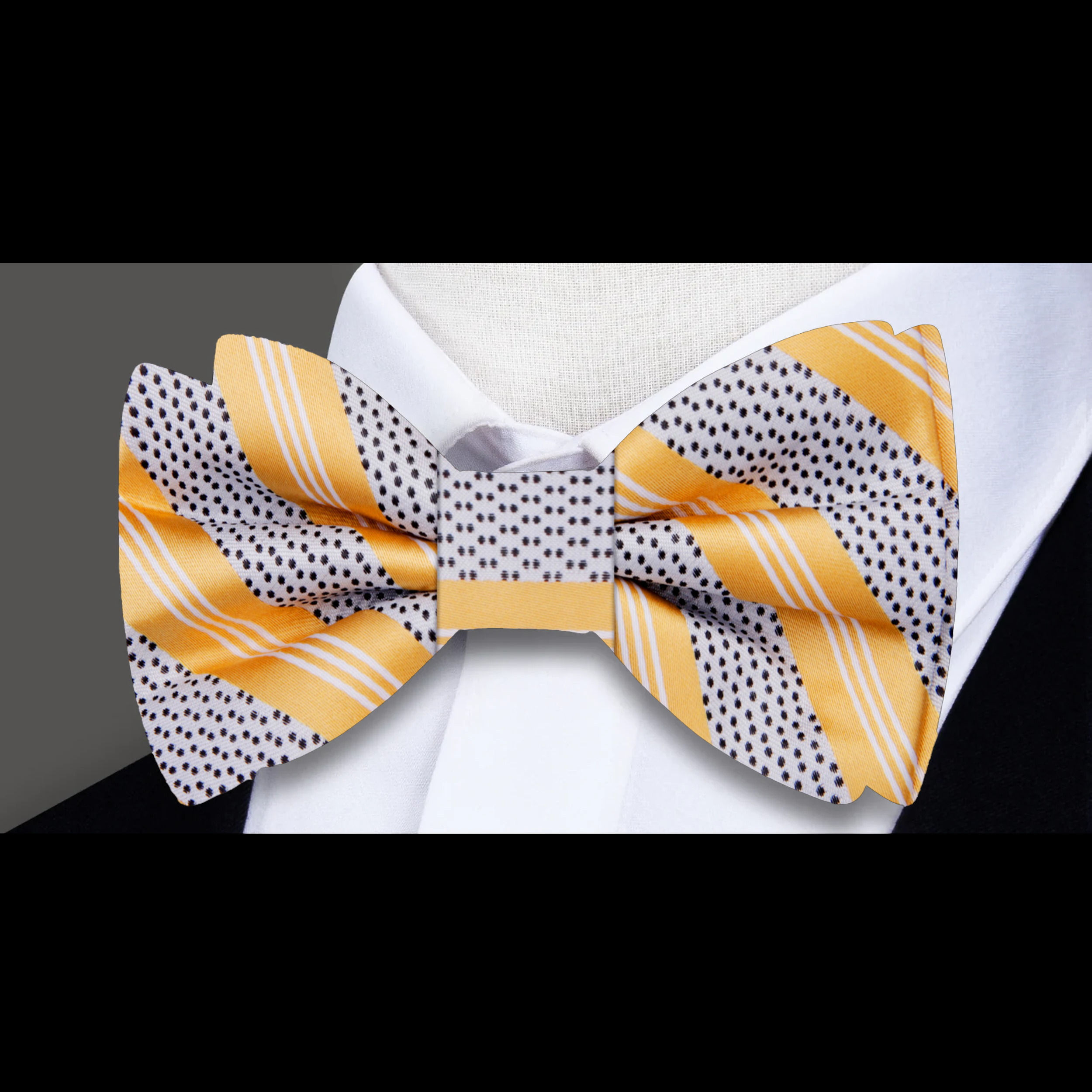 Stylish silver striped silk bow tie showcased with a charcoal suit, perfect for evening receptions.