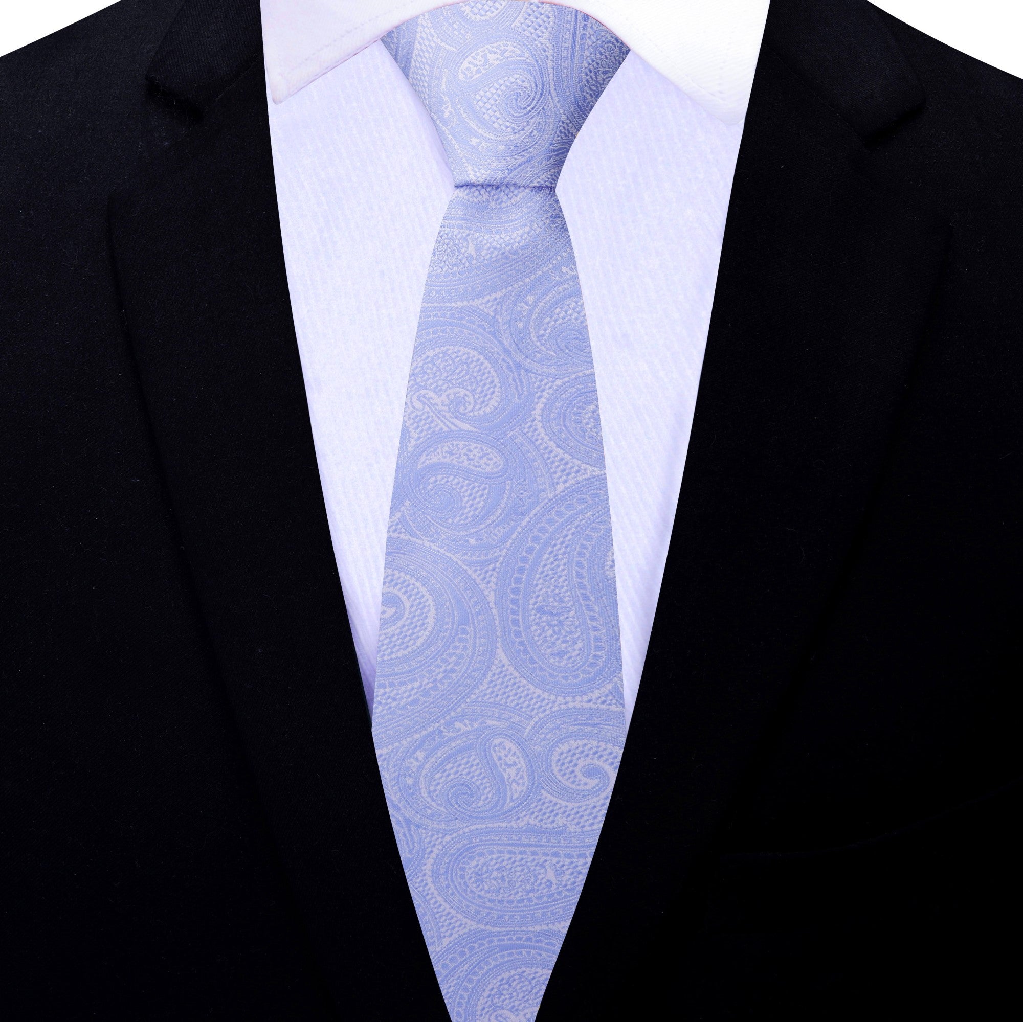 Styled shot of the grey paisley necktie paired with a crisp white shirt and navy blazer, ideal for office wear.