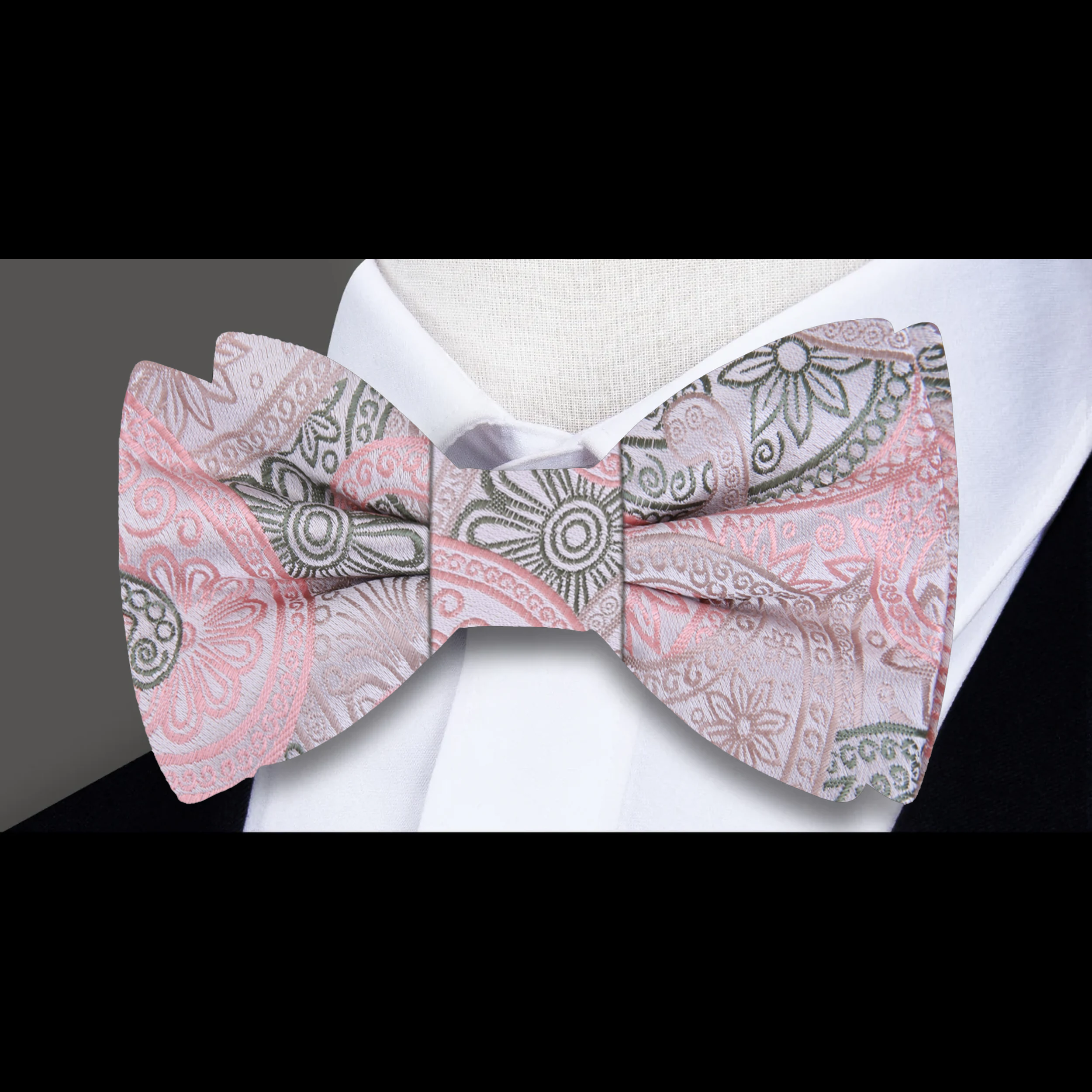 Front view of a pink paisley bow tie for men on a white shirt, suitable for weddings