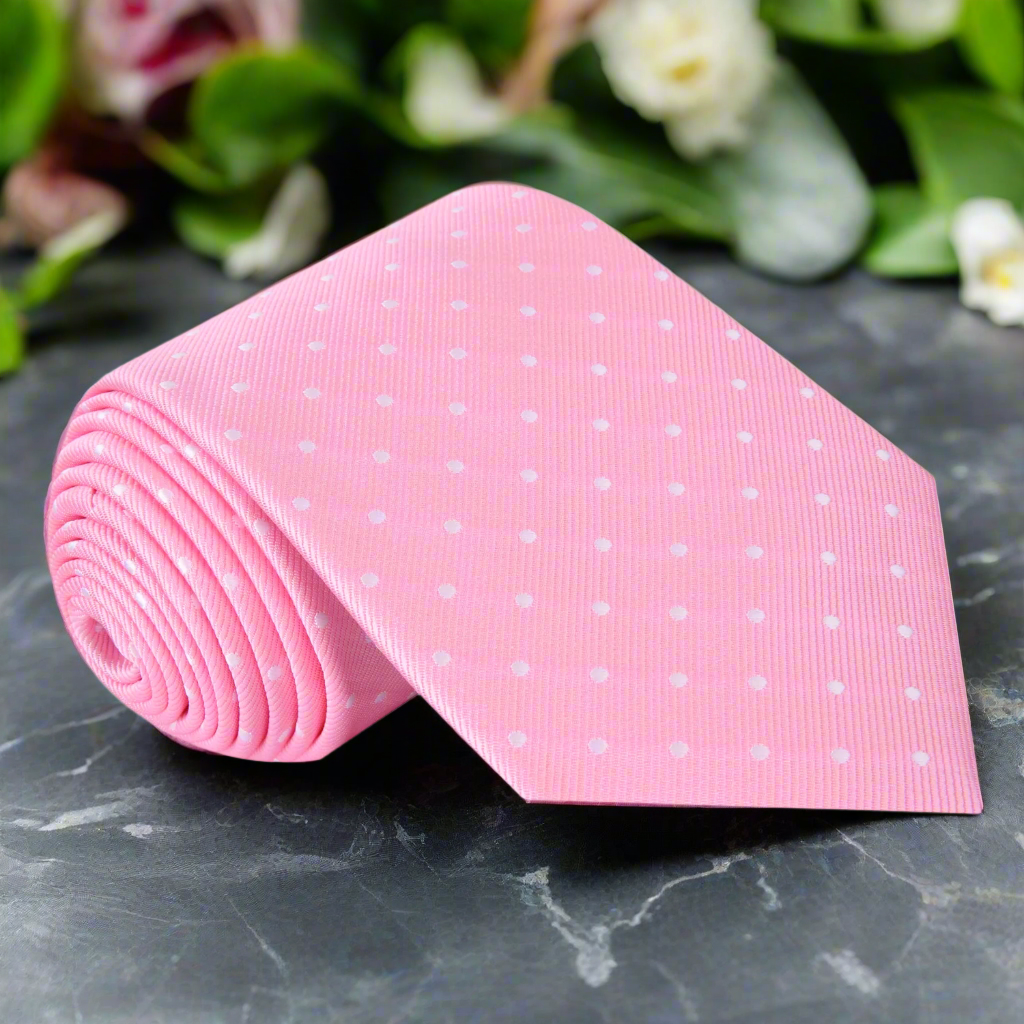 Close-up of blush pink silk tie with white dots, ideal for weddings or spring events
