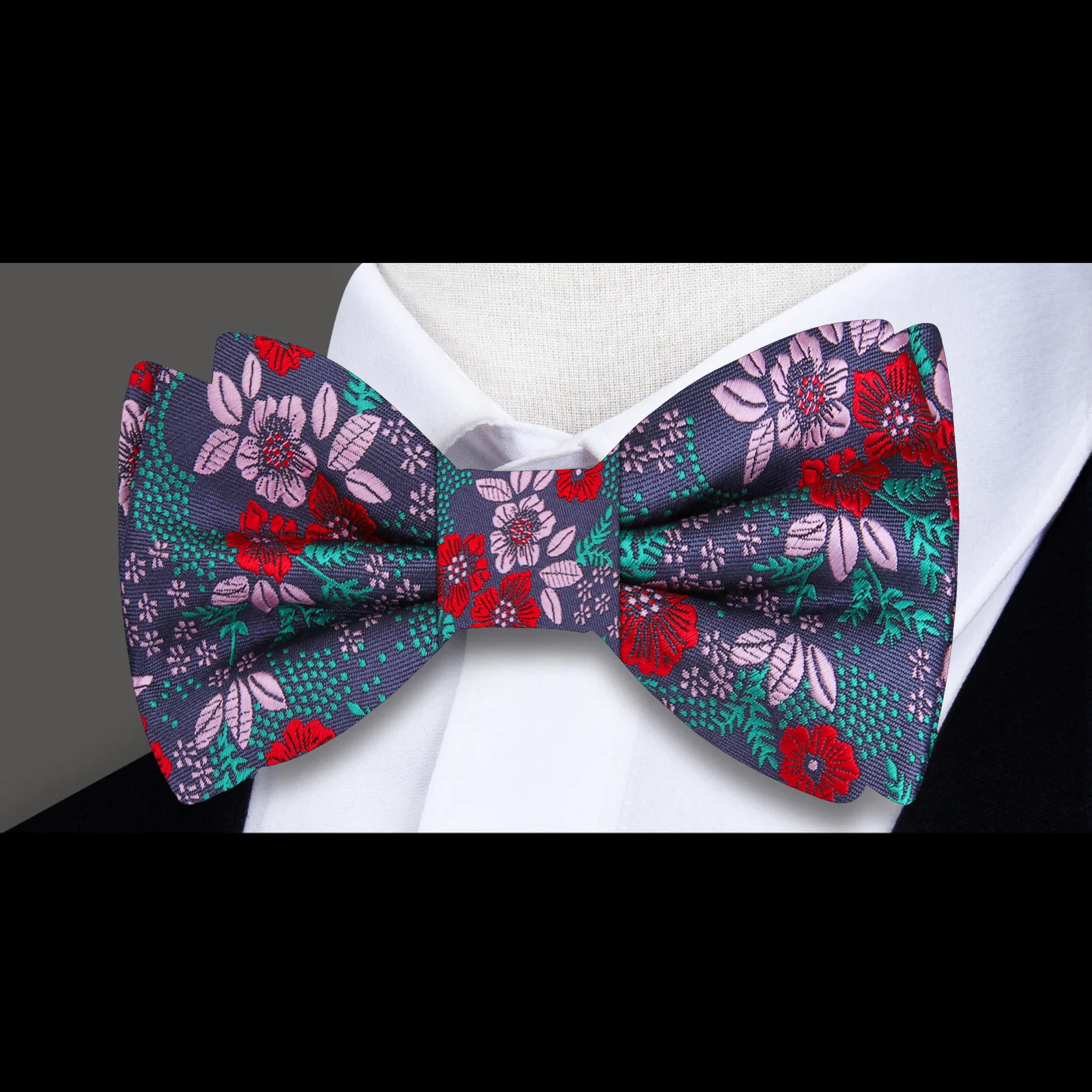 Close-up of a mens floral bow tie featuring intricate flower patterns in vibrant colors.