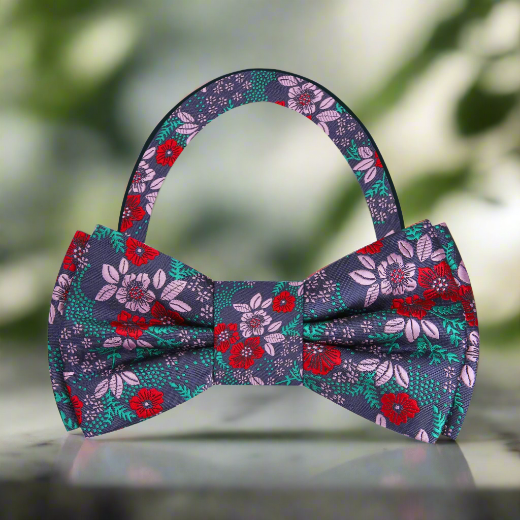 Stylish man wearing a floral bow tie with a crisp white dress shirt at a garden wedding.