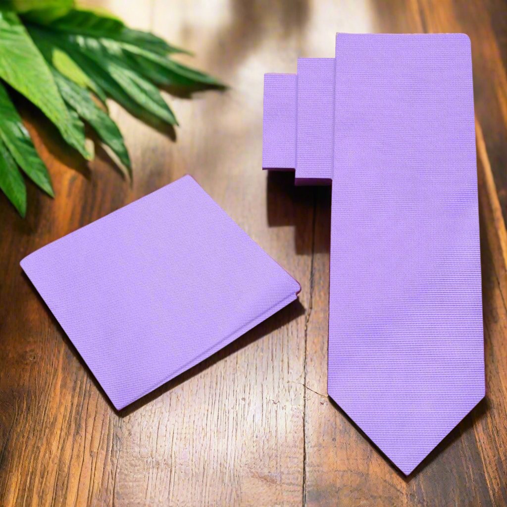 Elegant solid purple silk necktie displayed against a white background, showcasing its luxurious texture.