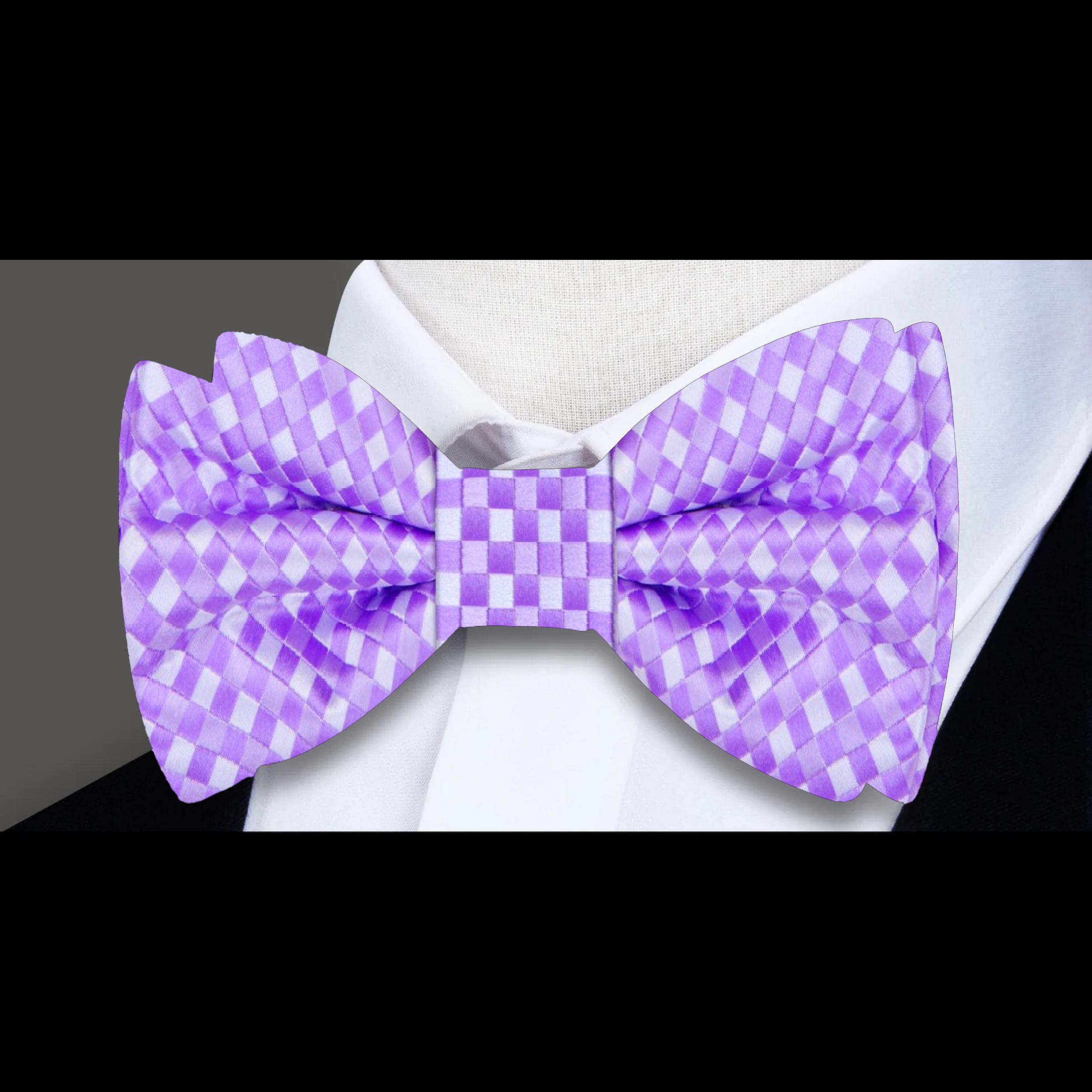 Man tying a self-tie bow tie in a formal setting, showcasing the elegant silk fabric