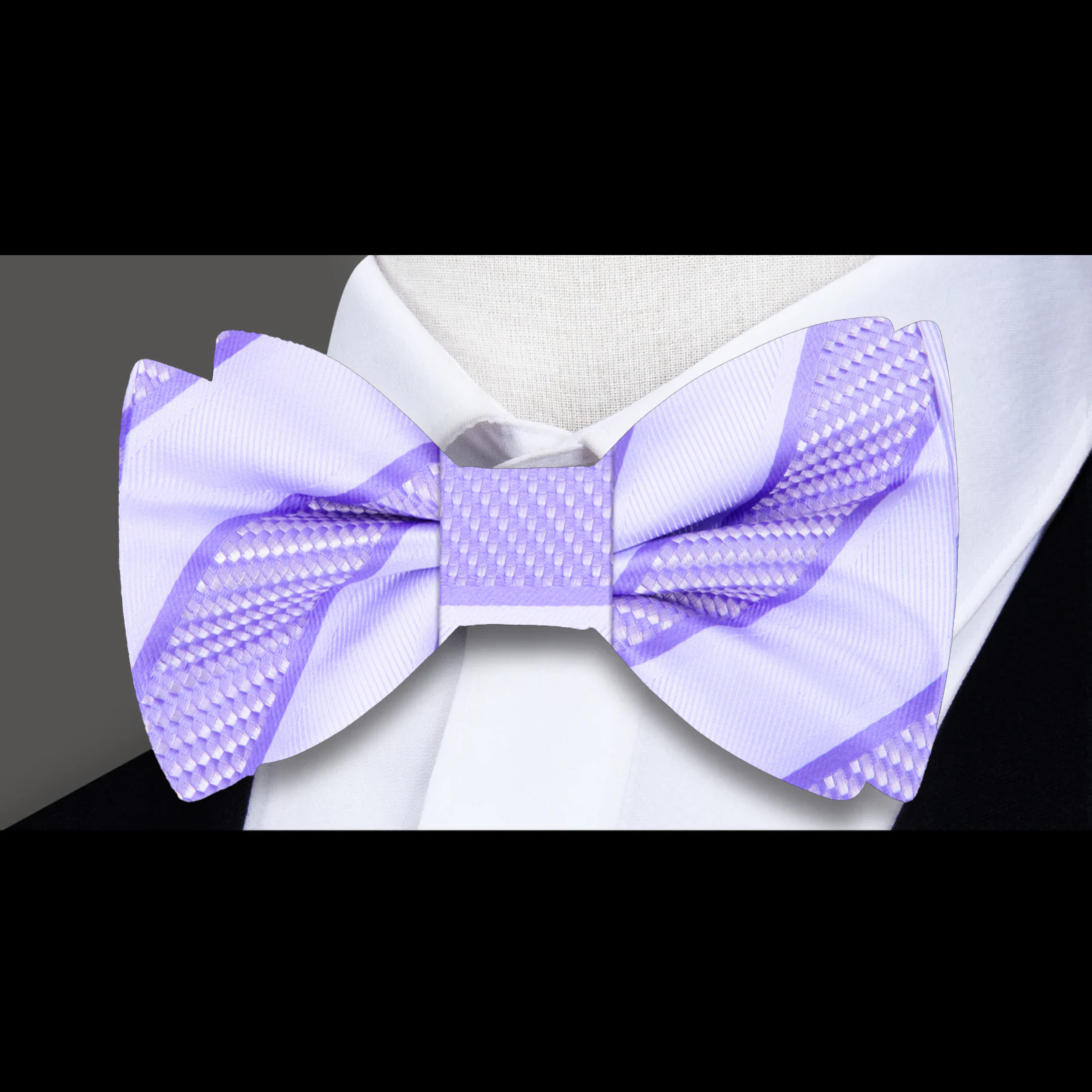 Close-up of the fabric pattern and texture of a yellow gold striped bow tie