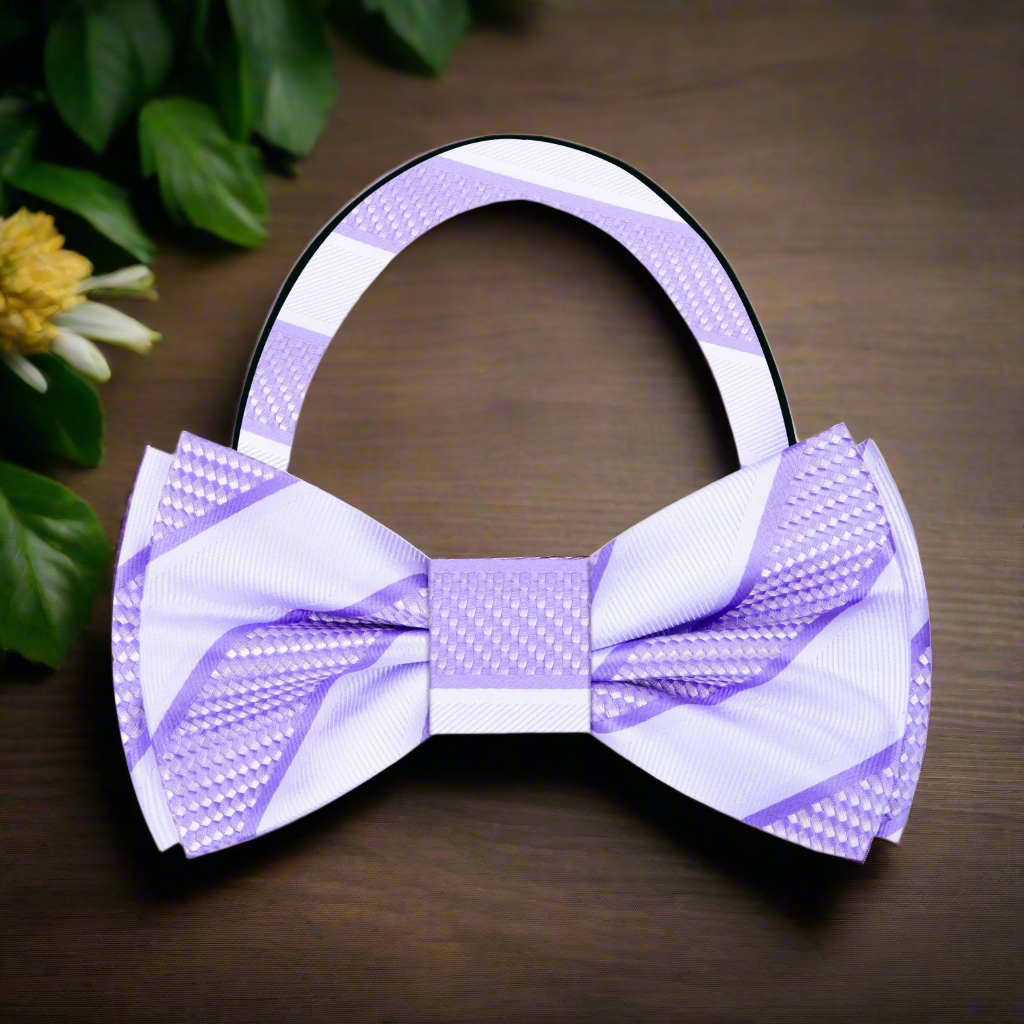 Model wearing a silk striped bow tie with a navy suit for a formal event