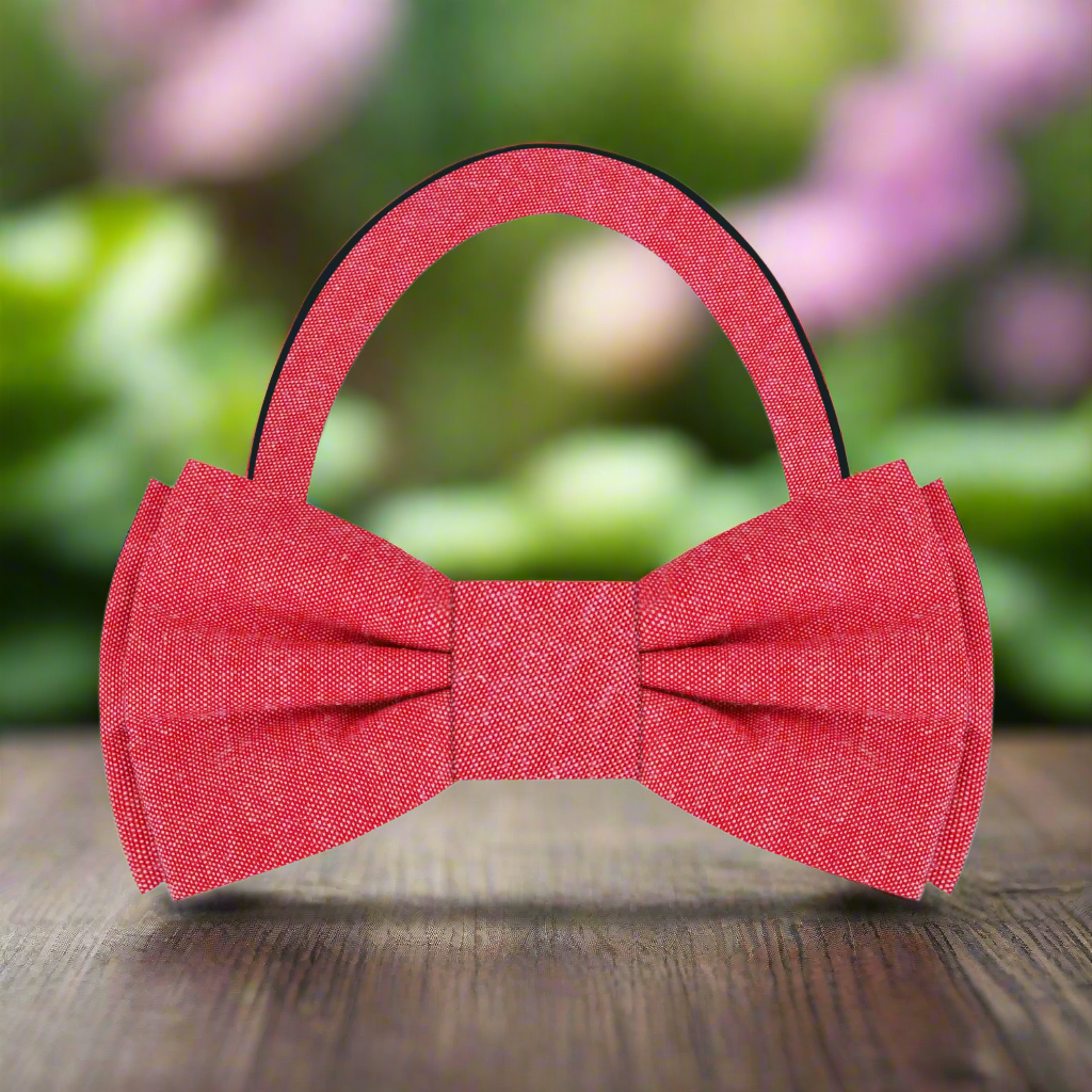 Fashionable man adjusting a deep red linen bow tie, showcasing effortless elegance