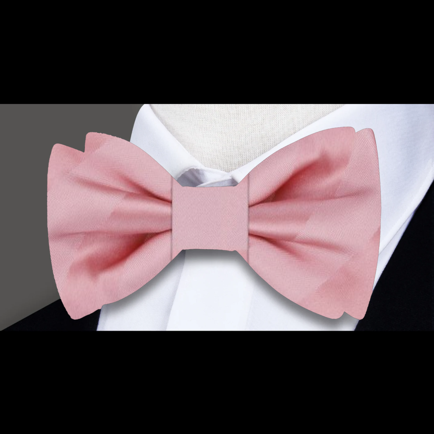 Close-up of a vibrant silk stripe bow tie with matching pocket square for formal occasions