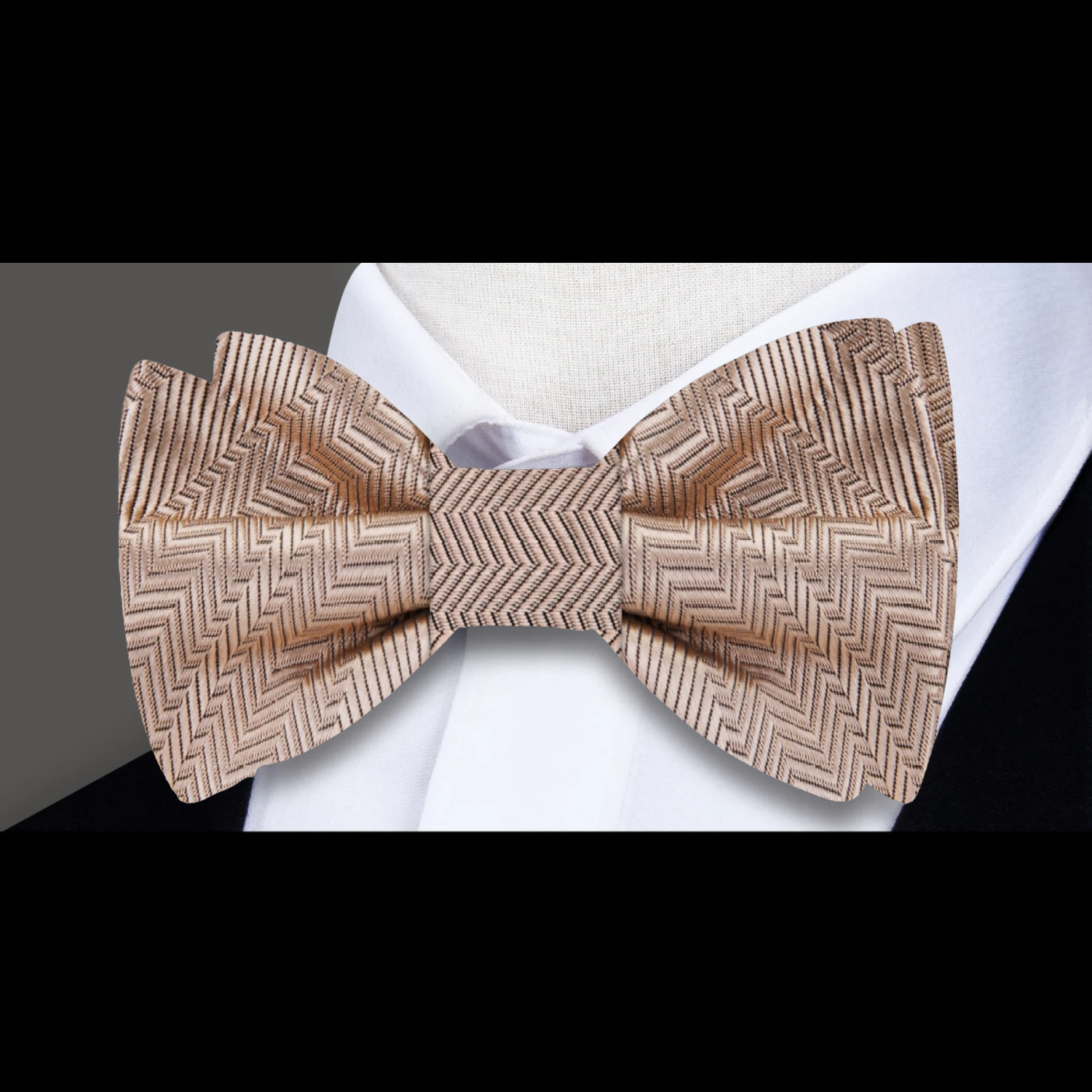 Elegant yellow bow tie with pocket square displayed on a light grey suit.