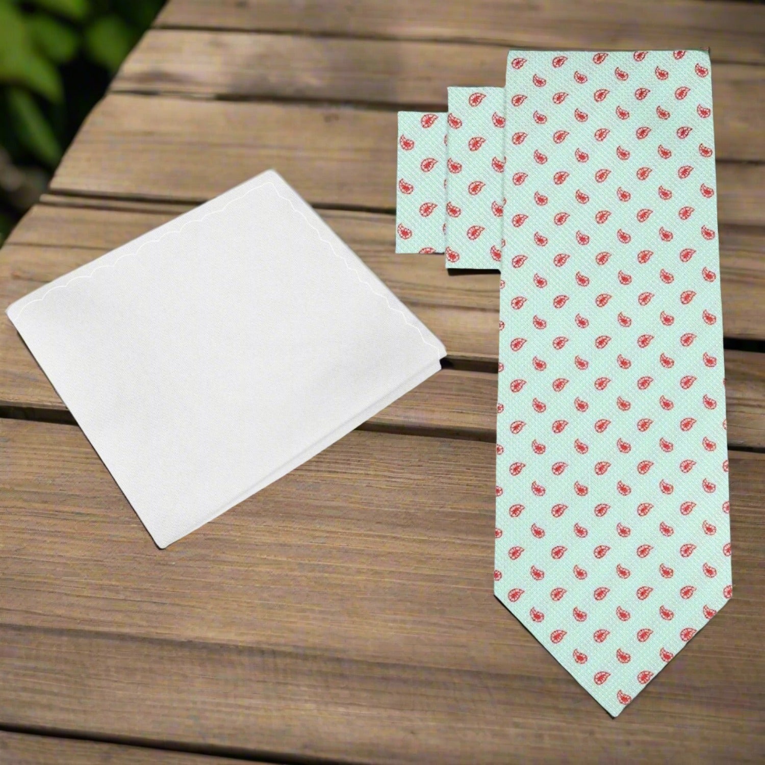Mint Green Silk Paisley Necktie with red paisleys, ideal for formal occasions.
