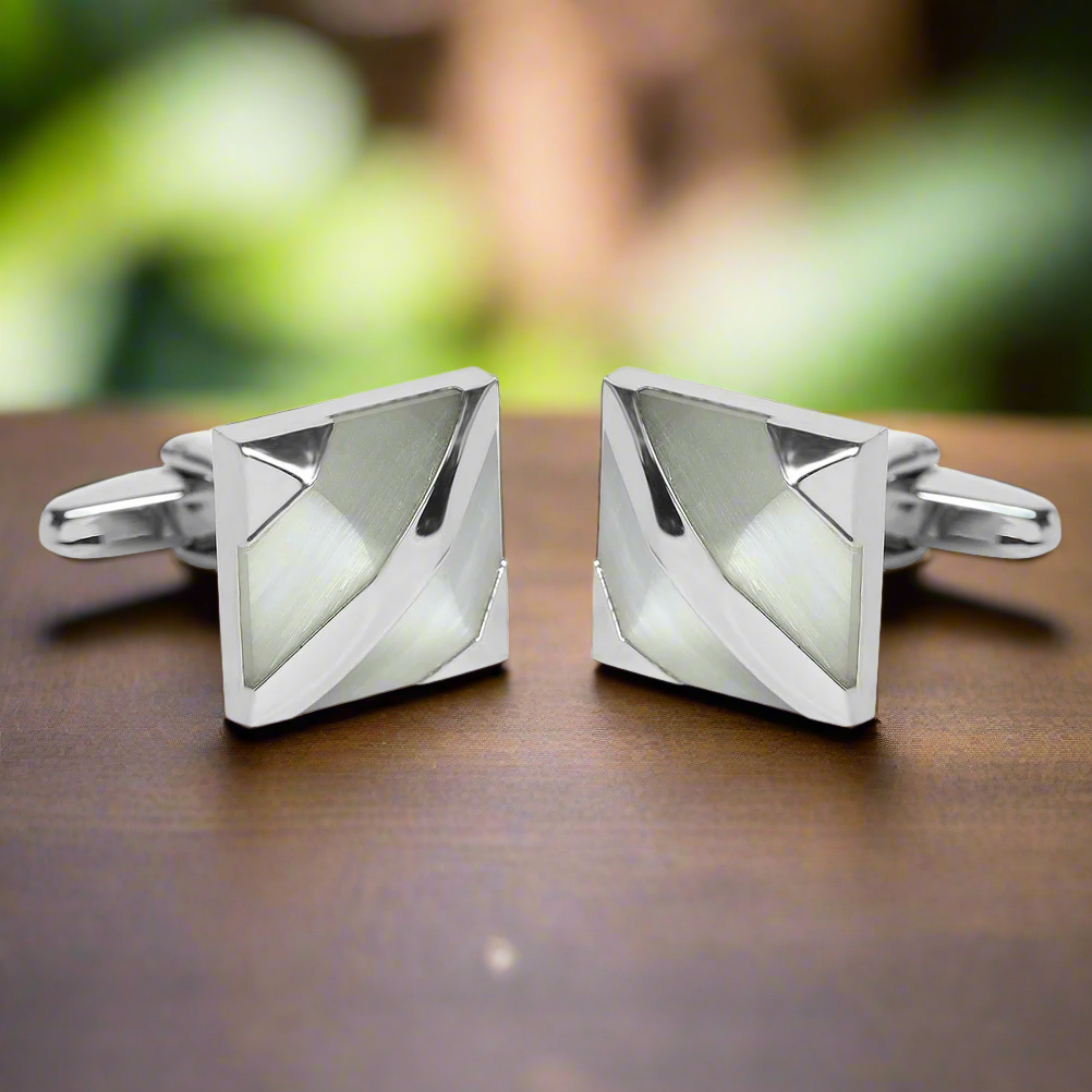 Close-up of modern chrome cufflinks with pearl inlay