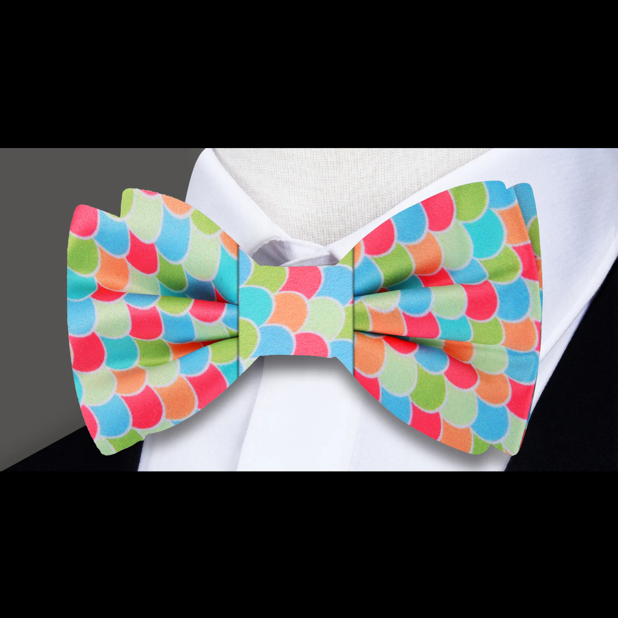 Close-up of silk bow tie featuring Easter-themed jelly beans and eggs in bright colors