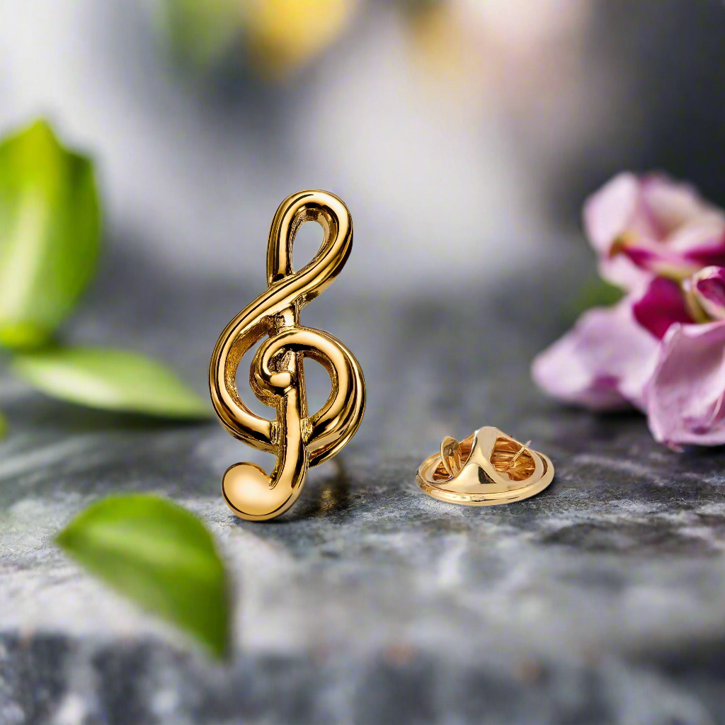 Close-up of a gold lapel pin featuring a treble clef symbol