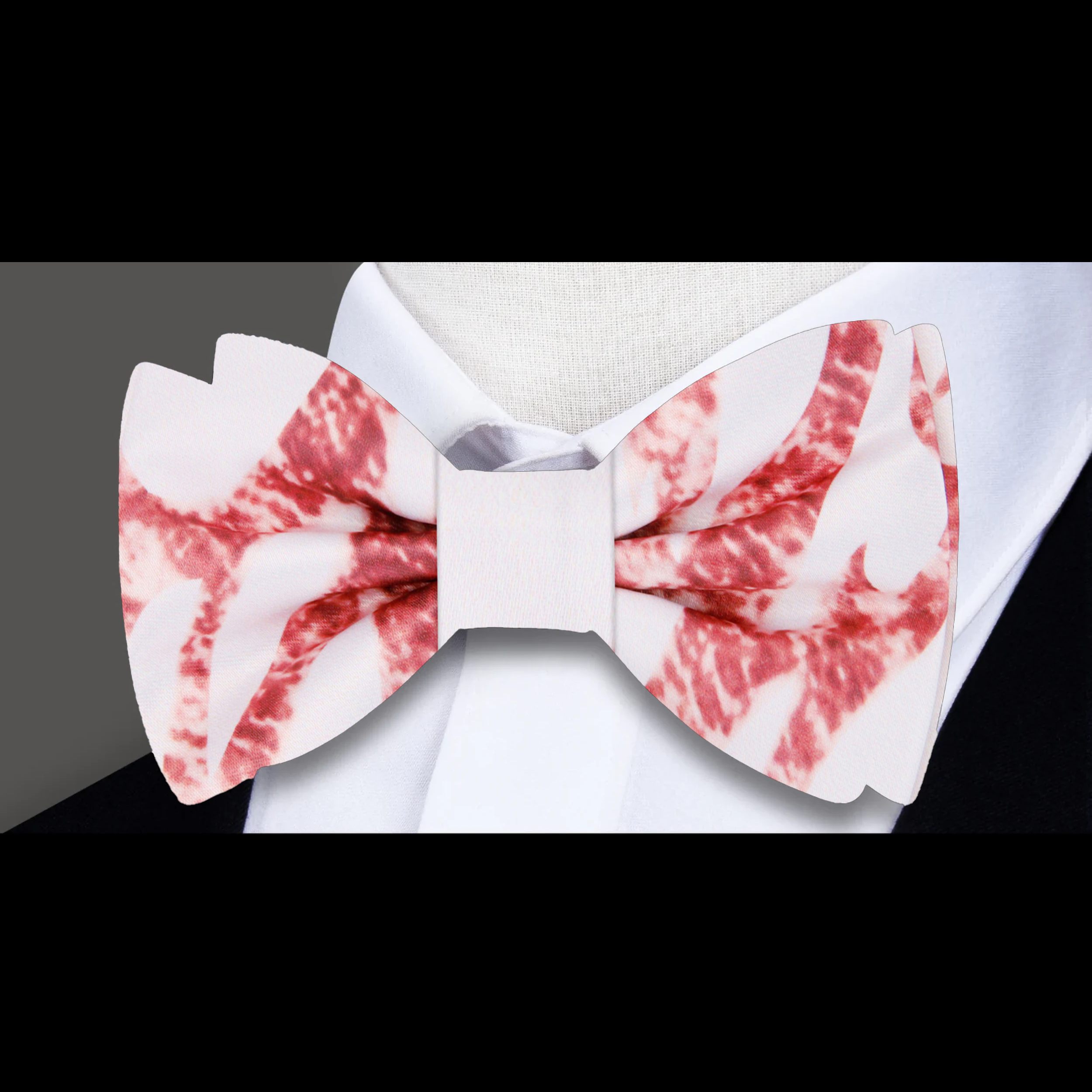 Rose gold marble bow tie paired with beige suit on mannequin, showcasing formal event look