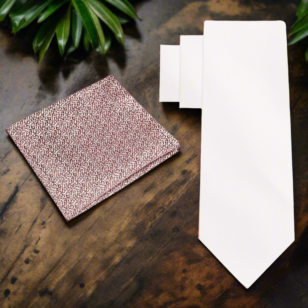 Ivory silk necktie elegantly displayed with a matching pocket square, showcasing its luxurious texture.