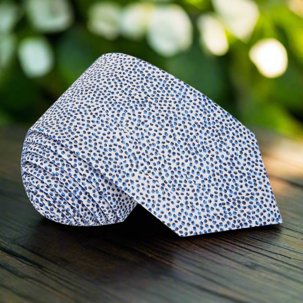 Close-up of modern silk tie with pebbles pattern in blue and black