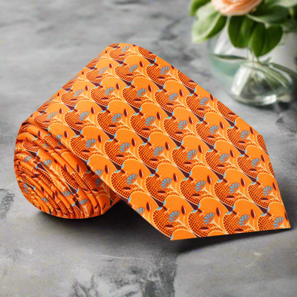 Close-up of vibrant orange silk necktie with apple slice pattern, ideal for spring occasions