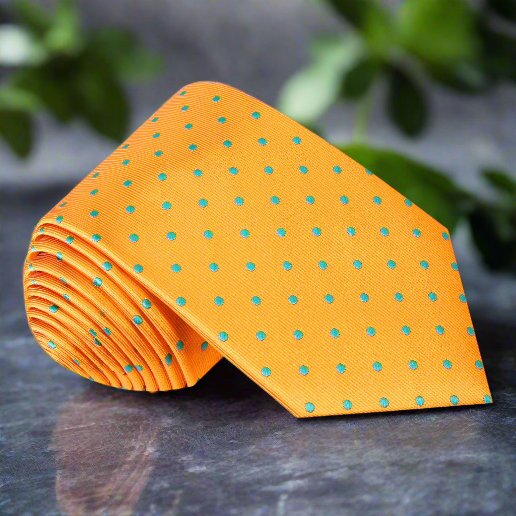 Vibrant orange polka dot necktie with aqua blue dots on a white background, ideal for weddings.