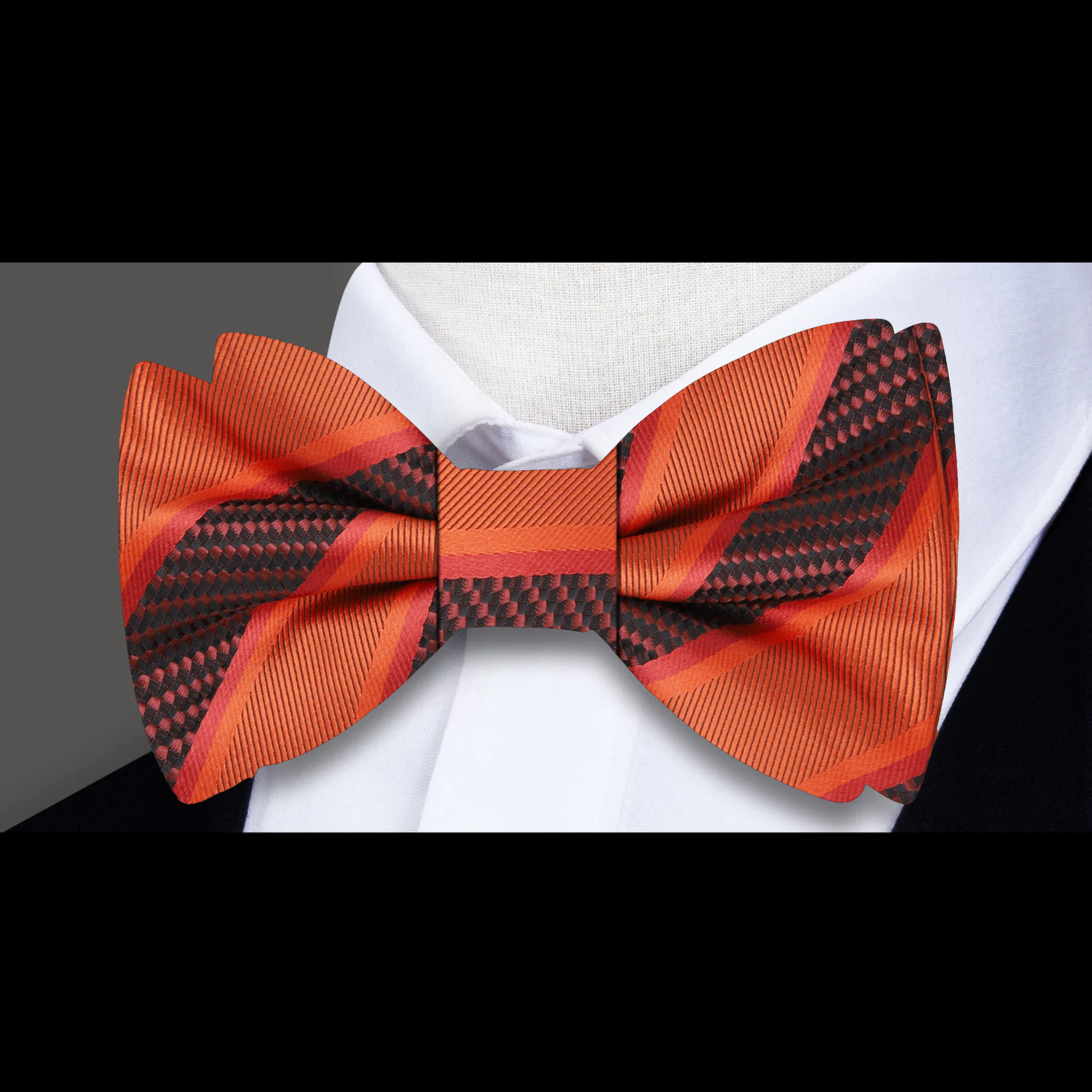 Close-up of the fabric pattern and texture of a yellow gold striped bow tie