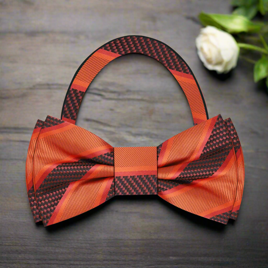 Model wearing a silk striped bow tie with a navy suit for a formal event