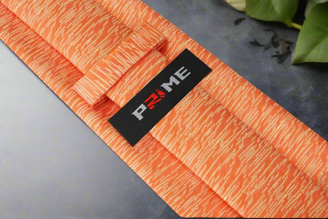 Man wearing an orange silk necktie with navy suit for a wedding