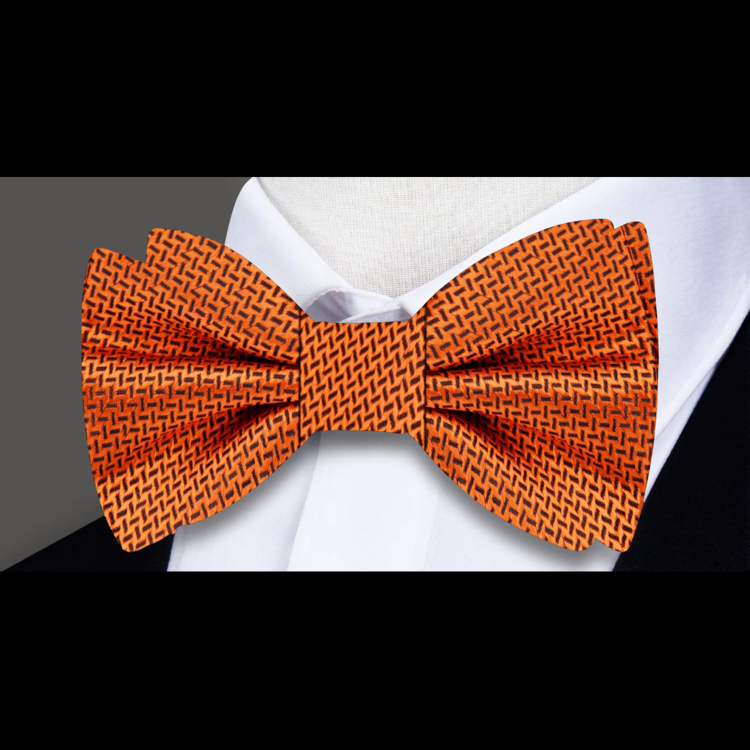 Cider Canyon Elegance Bow Tie alongside a matching pocket square on a tailored suit, perfect for formal occasions.