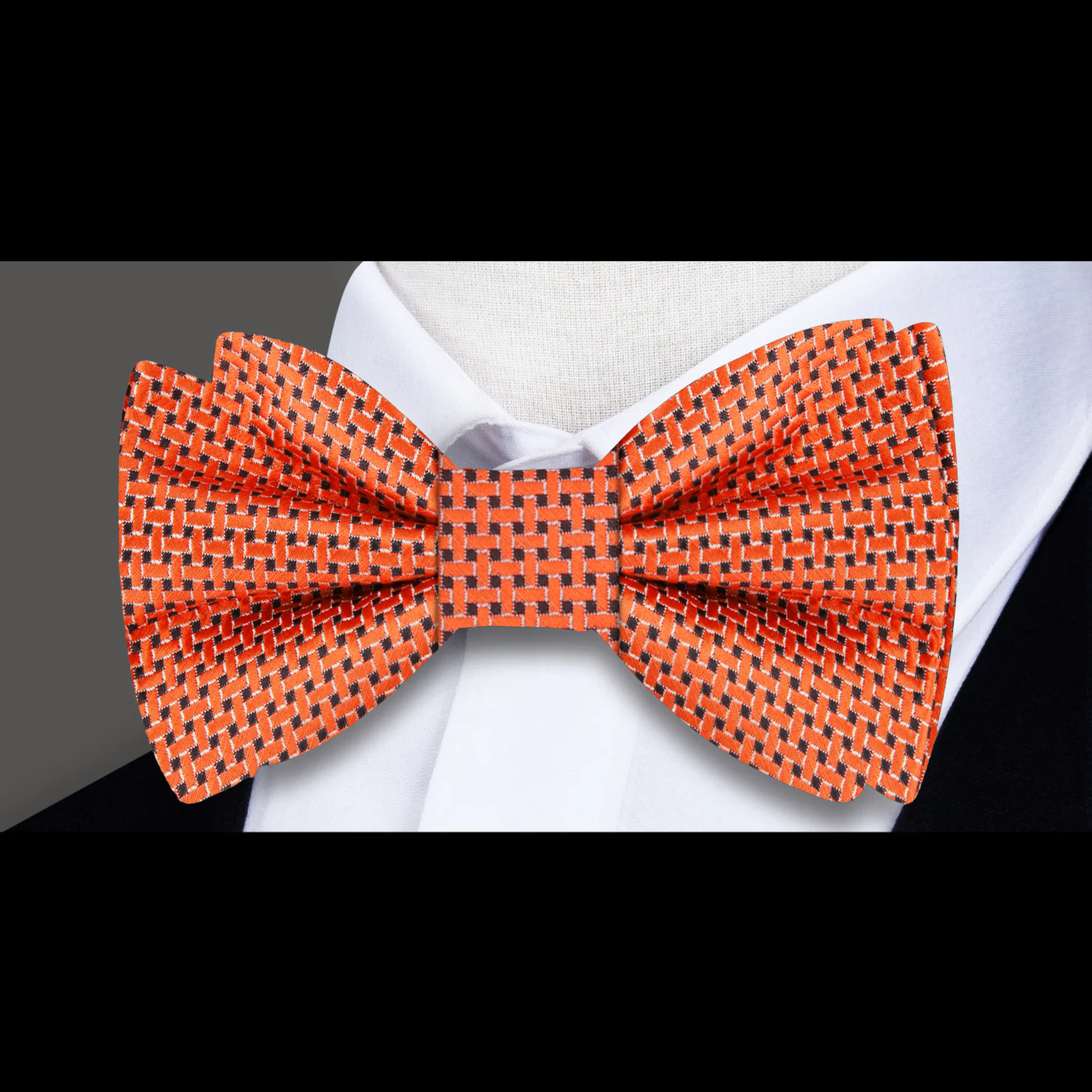 Detail shot of the self tie silk bow tie against a crisp white shirt, exemplifying autumn style.
